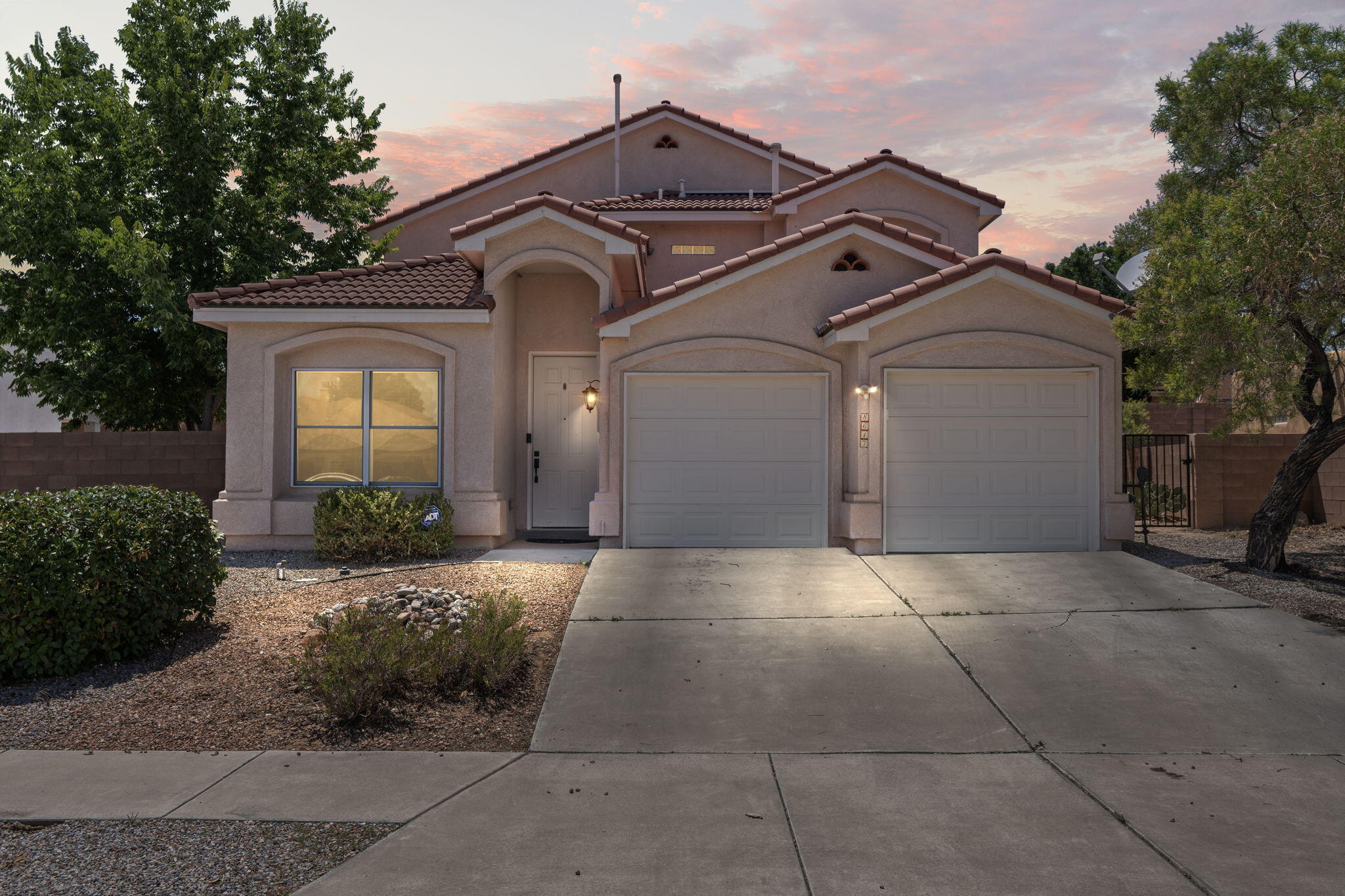 This beautifully crafted two-story home features an attached two-door, two-car garage and raised ceilings that fill the main living room with a bright, spacious feel. Inside, a thoughtful blend of tile and carpet flooring complements a functional kitchen complete with appliances and a pantry. Throughout the home, elegant rounded doorways and charming niches add architectural character. The primary suite offers a generous walk-in closet and an ensuite bath with his and hers sinks, a garden tub, and a separate shower. Step outside to a spacious walled backyard with a covered patio and storage shed. Ideally located near shops, dining, and freeway access, this home effortlessly combines comfort and convenience. Schedule your tour today to experience its inviting charm firsthand.