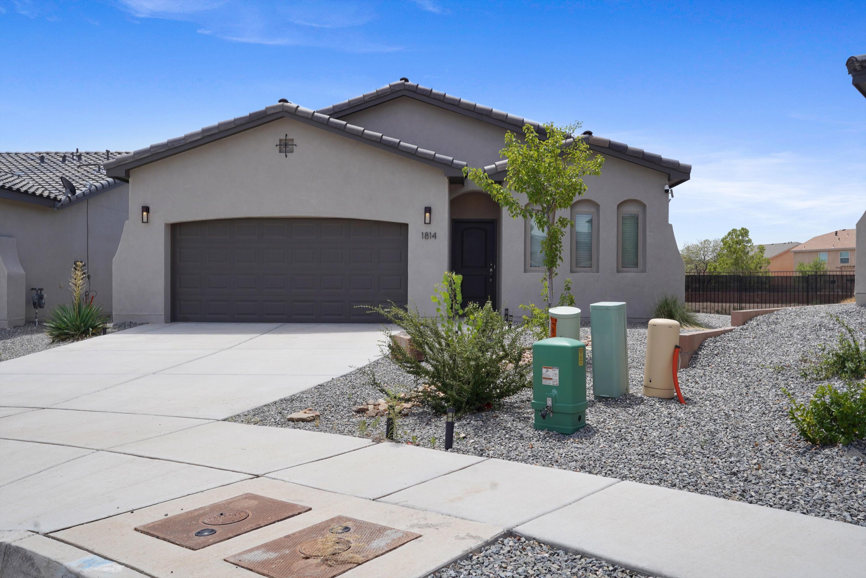 Welcome to this nearly-new, 2023-built home offering breathtaking views of the Manzano Mountains! Being one of the rare homes nestled on an oversized premium lot, this stunning property has an open-concept layout perfect for entertaining, with a spacious living area that flows effortlessly into the kitchen with a bright modern feel. The primary suite features a walk-in closet and private en-suite bathroom for comfort and privacy. Two additional bedrooms offer flexibility, with a dining space that can also be utilized as your home office. A buffer zone with walking trails and parks gives extra privacy. Centrally located near shopping centers, schools, and restaurants. Don't miss the chance to own this exceptional home!