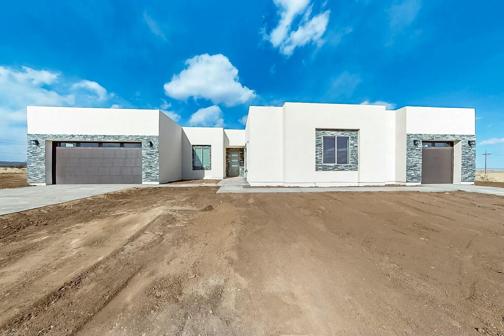 Welcome to your Stunning custom new home! Nestled on 2.5 acres of land in the serene Edgewood, NM. Only 35 miles from downtown Albuquerque. This was custom crafted has a beautiful open concept!  5 bedrooms, including an attached studio with its own private garage, this property offers both luxury and functionality. Primary Suite is the ultimate retreat with two walk-in closets, a freestanding tub, and a modern standing shower for your relaxation. The heart of the home features an open concept a cozy gas fireplace, designed with unique backsplash and kitchen island perfect for hosting or enjoying a quiet evening. And did we mention tile throughout the home! Don't miss your opportunity to see Cleveland amazing mountain view. Schedule your realtor today!