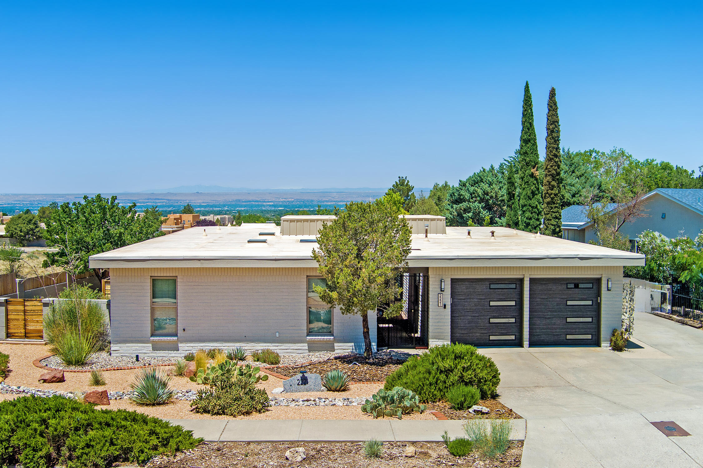Foothills at it's finest and thoughtfully updated, this single story home has style. An inner courtyard greets you and is one on the many indoor/outdoor living spaces. Modern kitchen with an oversized eat at bar adds to the abundant counter space. The newer cabinets have glass fronts to show off your stemware. Walk-in pantry, and the butler's bar gives a peek into the courtyard, and all of this flows into the dining and living rooms. The second living space has a wall of windows to take in the well designed back yard, sunset & night views. 4 bedrooms & 2.5 baths, the primary suite has a large walk in closet, & double vanity. New Hvac including refrigerated ac & thermal windows in '19. Home is on .34 of an acre with only 1 neighbor, a park across the street, mountain views & nearby trails.
