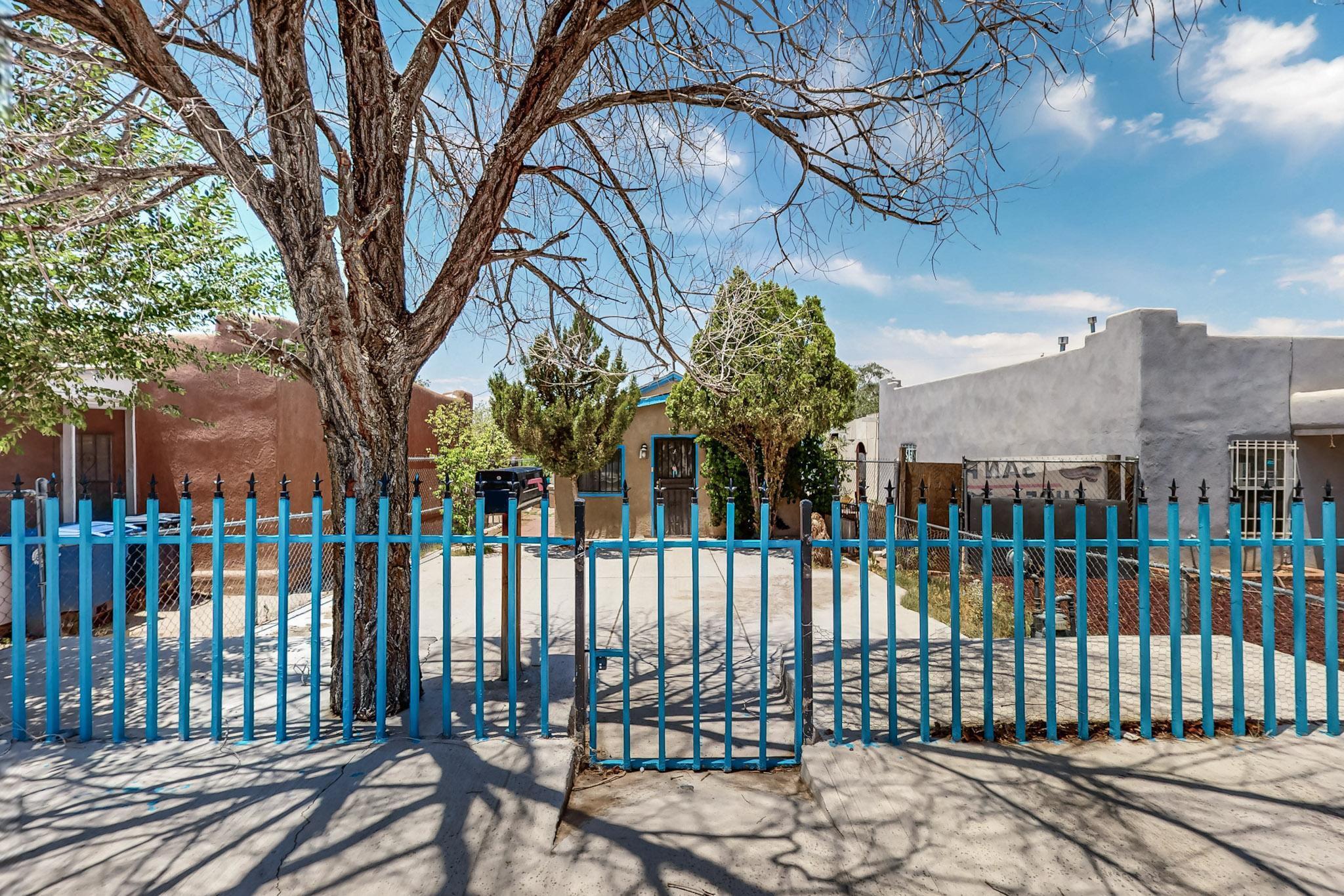 Charming adobe-style 1BD/1BA home in the heart of Albuquerque! Fully fenced with gated driveway, this 835 sq ft home features tile floors throughout, a cozy kitchen with gas stove, spacious living area, and flexible entry/office space. Enjoy a large backyard with mature trees, covered patio, storage shed, and a traditional adobe horno (outdoor oven). Located minutes from downtown, UNM, and transit. Great for first-time buyers, investors, or creatives looking for a unique space. Zoned MX-T (buyer to verify).