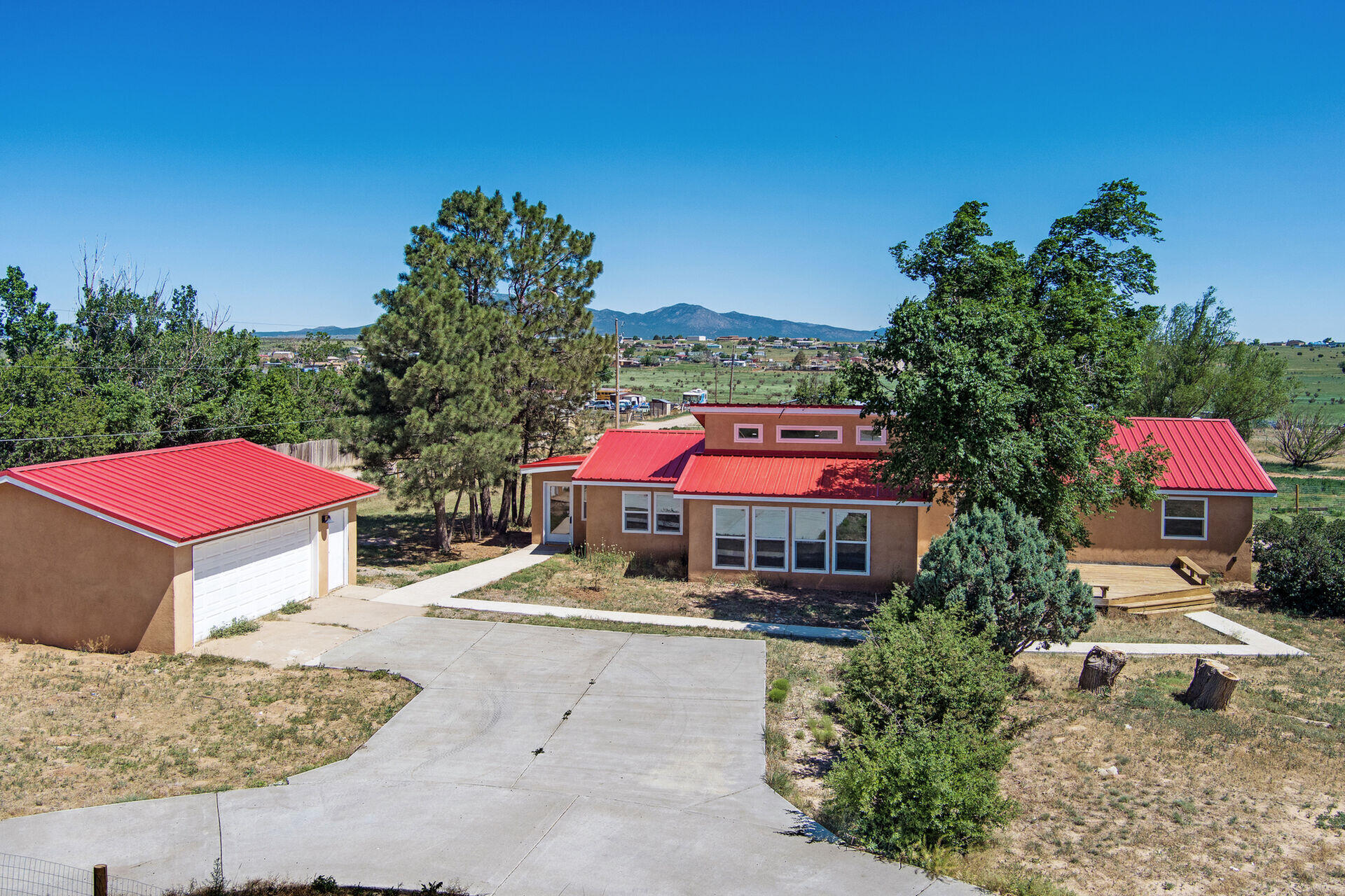 Welcome to this beautifully renovated contemporary bungalow! This bright and functional floor plan offers the perfect features for East Mountain living. Enjoy the expansive space and stunning views on this fully fenced one-acre lot, complete with two drive-in gates for easy maintenance and access.The huge deck off the living room is ideal for entertaining--imagine your cozy patio furniture and barbecue grill! The front foyer and utility room off the covered back patio serve as excellent transition spaces that could easily function as mudrooms, providing ample storage.The primary bedroom boasts a spacious walk-in closet, a beautifully updated full bath, and a sliding glass door that leads to a small sun deck. The fully remodeled kitchen features new cabinets, appliances, butcher​​‌​​​​‌​​‌‌​‌‌‌​​‌‌​‌‌‌​​‌‌​‌‌‌ block