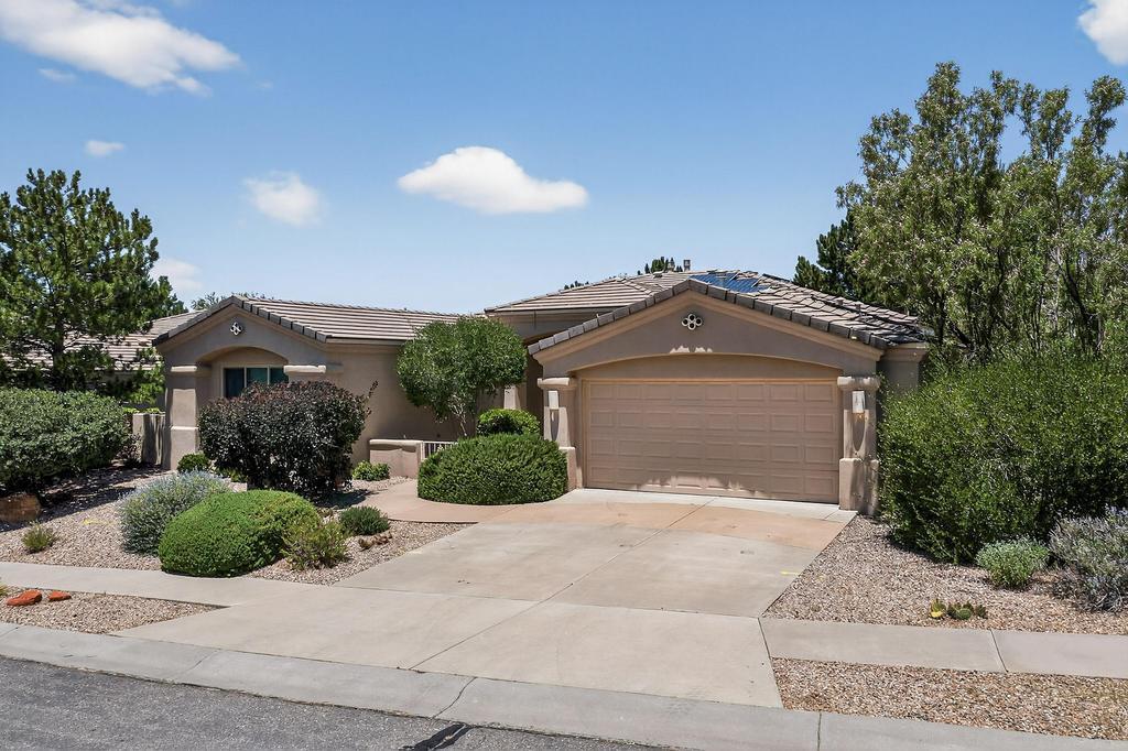 Welcome to this beautiful one-story custom Mechenbier home in High Desert. With 3 bedrooms, 2 bathrooms, and over 2300 sq ft of space, this home offers comfortable living in a coveted location. With refrigerated air, new carpet, & owned solar, it's move in ready. The large kitchen features double wall ovens, a smooth cooktop and tons of counter and cabinet space. The primary bedroom has a walk-in closet & bathroom w/ a tub, shower, & double sink vanity. The 2 kiva fireplaces, wood beams, and small touches of adobe brick provide architectural interest & a subtle southwestern feel. The low maintenance backyard features a large covered patio, trees, & a sprinkler system. Close to hiking & biking trails and Elena Gallegos Open Space w/ convenient access to KAFB/Sandia Labs and I-40.