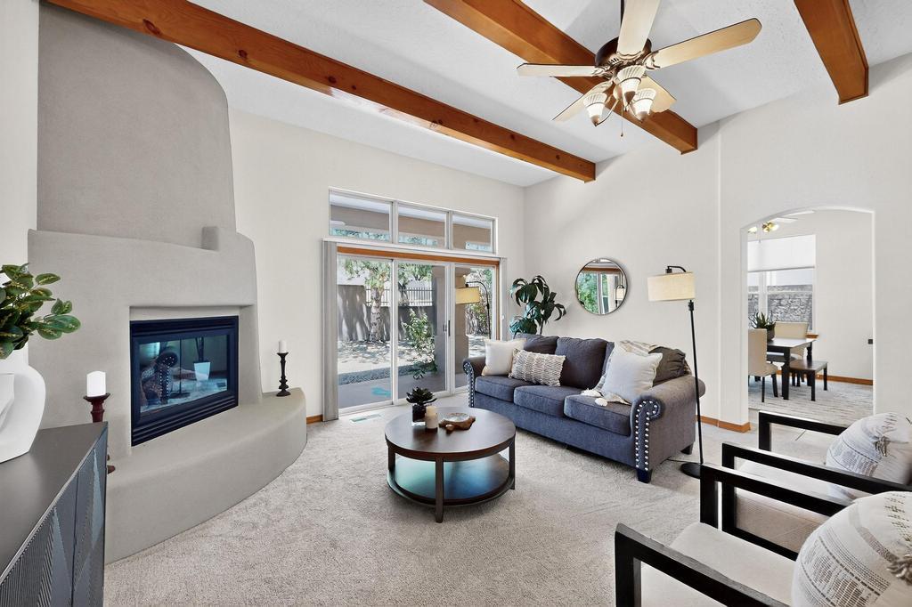 Welcome to this beautiful one-story custom Mechenbier home in High Desert. With 3 bedrooms, 2 bathrooms, and over 2300 sq ft of space, this home offers comfortable living in a coveted location. With refrigerated air, new carpet, & owned solar, it's move in ready. The large kitchen features double wall ovens, a smooth cooktop and tons of counter and cabinet space. The primary bedroom has a walk-in closet & bathroom w/ a tub, shower, & double sink vanity. The 2 kiva fireplaces, wood beams, and small touches of adobe brick provide architectural interest & a subtle southwestern feel. The low maintenance backyard features a large covered patio, trees, & a sprinkler system. Close to hiking & biking trails and Elena Gallegos Open Space w/ convenient access to KAFB/Sandia Labs and I-40.