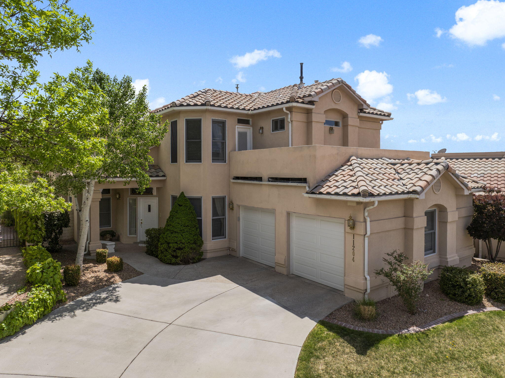 Tucked back in Tanoan East on the golf course, is this beautiful, updated home. Soaring ceilings, wood floors and a sweeping staircase are welcoming! Lovely fireplace anchors the Living room. Beyond is the dining area with backyard, golf course views. Modern kitchen: granite, wine cooler, double ovens, gas range, microwave drawer, hidden screen door.  Oversized pantry! Family room/ den/ hobby/ guest room is large, with huge storage closet.  3/4 bath.  Primary suite includes sitting room, triple-sided fireplace, and deck that looks over the greens. Luxurious full bath, walk-in closet.  2 more BR upstairs, JnJ bath.  All renovated!  Deck that looks out over the Sandias.  Tankless hot water, 2 coolers, 2 heaters.  Peaceful place to live!