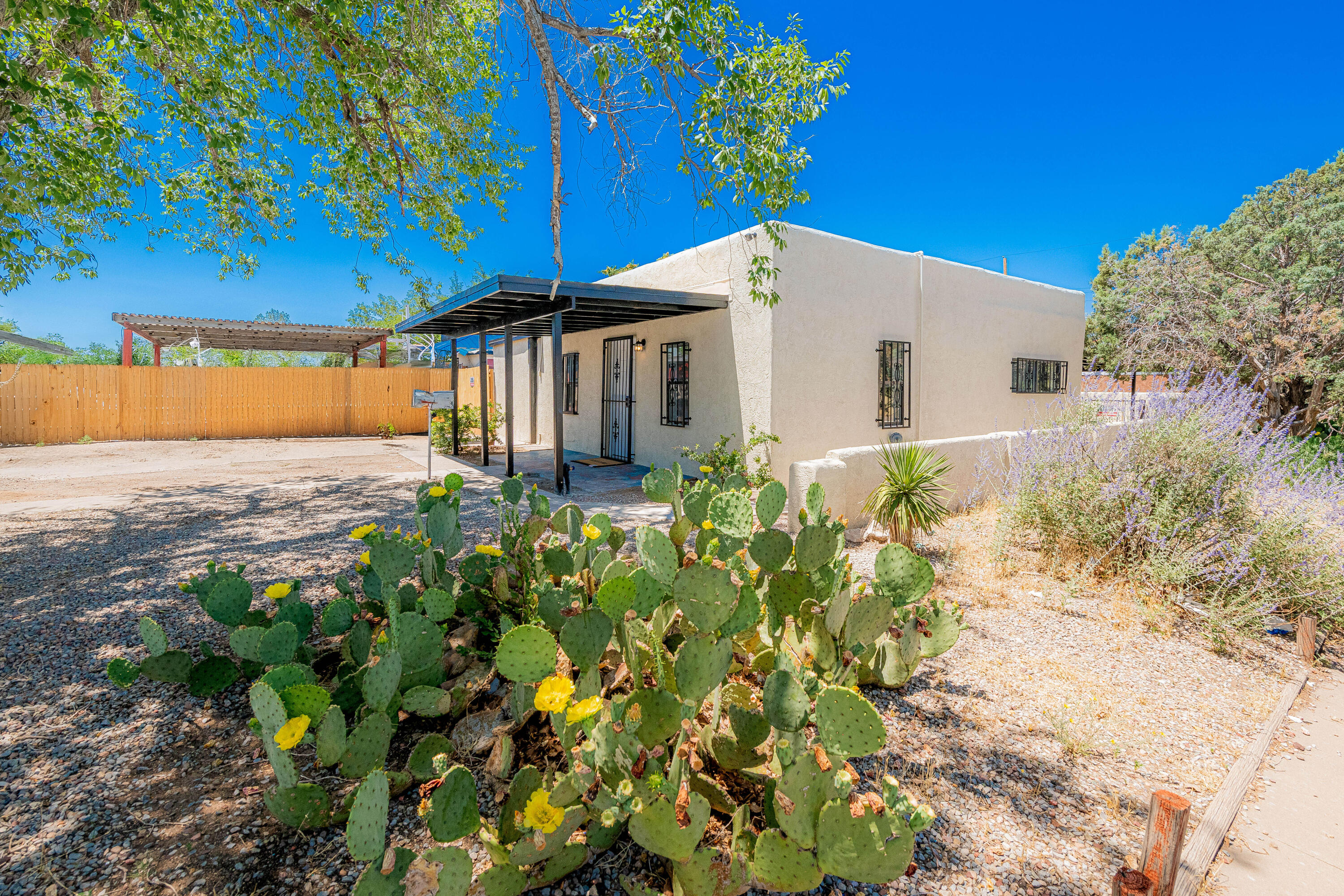 Beautifully remodeled 3-bed, 2-bath home with a separate casita featuring its own driveway, kitchen, and full bath. Both the main home and casita boast brand-new laminate flooring, cabinets, countertops, sinks, light fixtures, and fresh interior paint. The main suite and casita each feature stunning new tiled showers. Enjoy cozy evenings by the fireplace in the main home. Additional upgrades include new stucco, new TPO roof and updated lighting throughout. A perfect setup for guests, rental income, or multigenerational living!