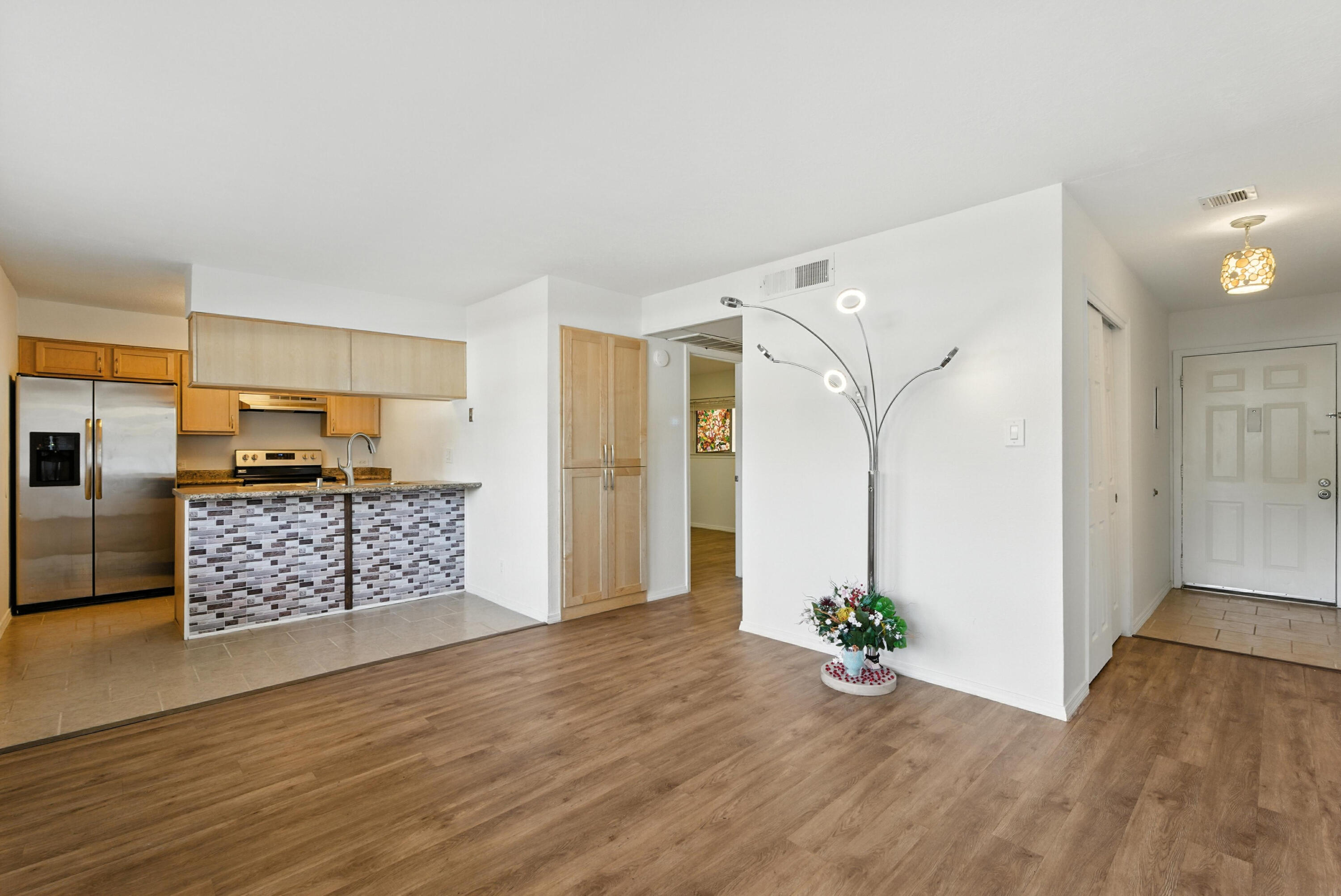 This ground level corner home is located in the Atrium Condo Community. It has been well maintained and ready for it's new owner. The home features an open living room and kitchen area with the bedroom situated down a hall for privacy. The new appliances will stay along with the washer and dryer. This home has everything you need to move right in. Relax in the private patio that provides shade and your own private outdoor space. There is also a community pool for those hot days. The HOA covers everything except the electricity, including TAXES. Come see this gem today!