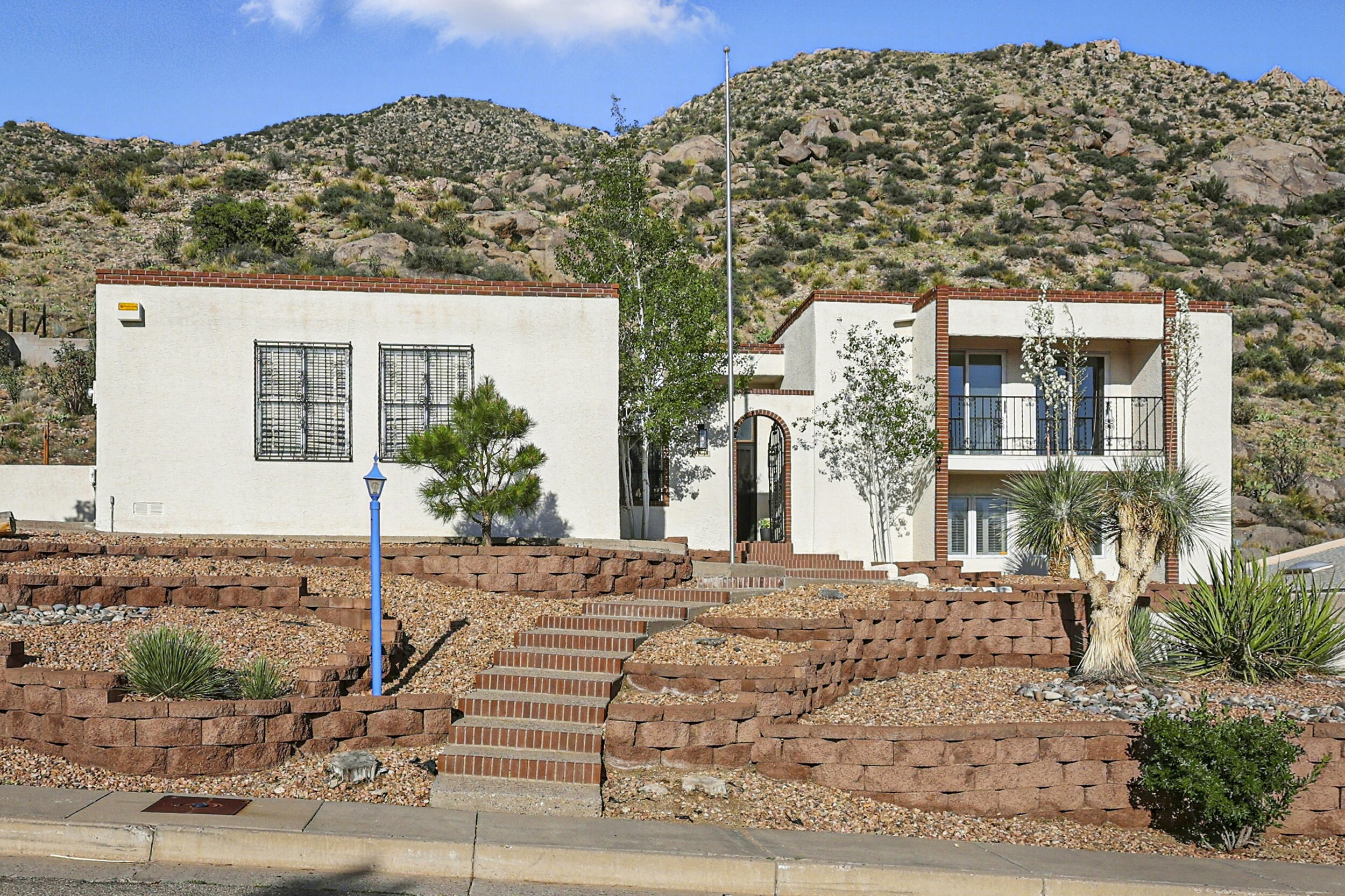 Stunning updated foothills home backing up to the Sandia mountain open space. Enjoy city views, and mountain views. Spacious split level home. Large kitchen with Ample granite counter space and cabinets, opening up to a formal dining space with a breakfast nook. Separate living room with tons of natural light. New flooring high end LVP and Carpet. Freshly painted, New roof, new furnace, new sprinkler system, Updated electrical system. New fixtures and hardware. Updated bathrooms. Private primary bedroom with separate sinks and walk in closet. Enjoy the sunsets and city light views in the evening on the private balcony. Three additional bedroom with large closets. Rare lot in the foothills, the backyard is the mountains.