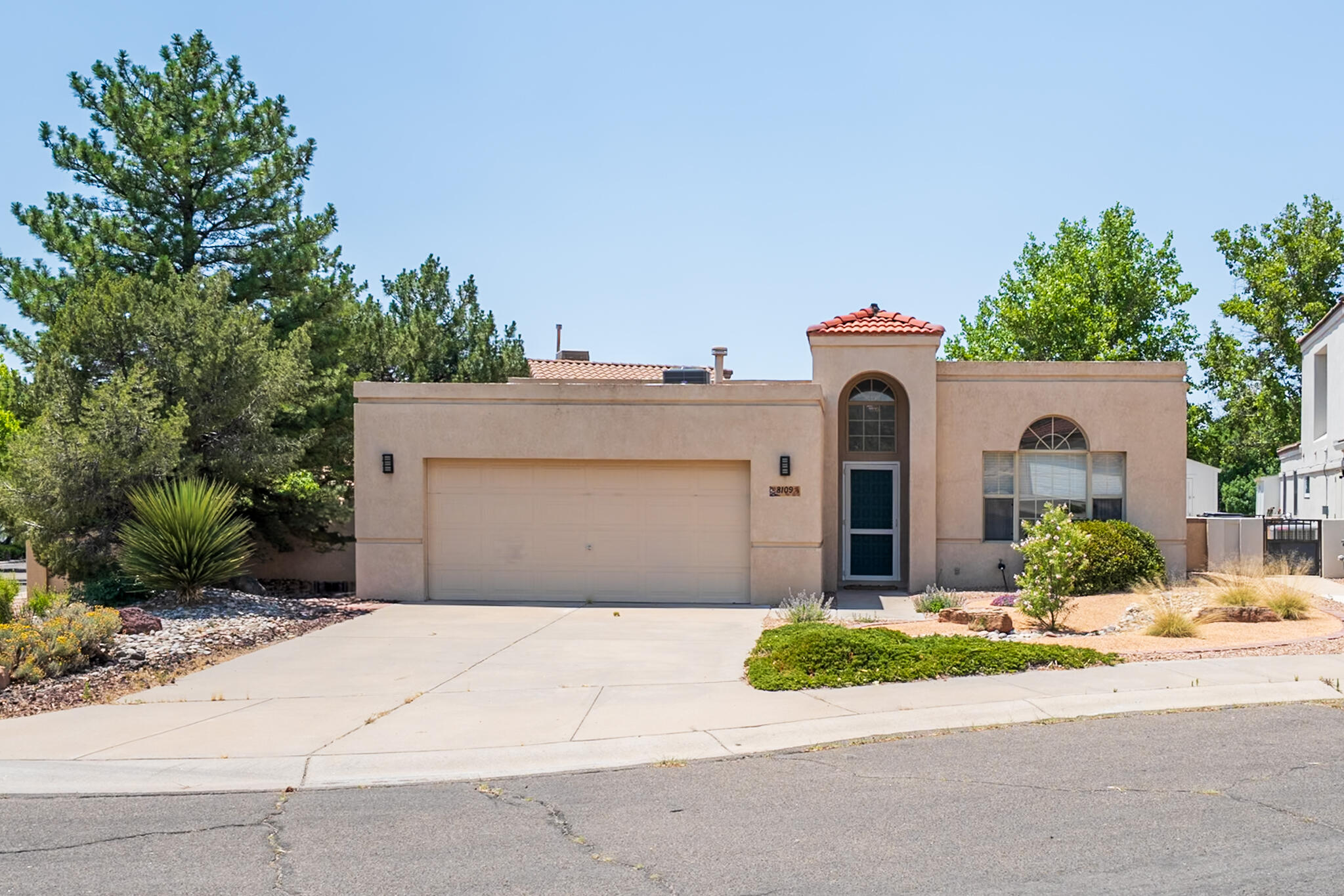 Welcome to 8109 Oakland, a beautifully updated custom home located on a desirable corner lot in a quiet cul-de-sac. This East-facing property offers 1,801 square feet of living space with breathtaking views of the Sandia Mountains and direct access to Noreste Park's walking and biking trails. This 3-bedroom, 2-bathroom home features a bright and open floor plan with high ceilings and oversized view windows that fill the space with natural light. Recent renovations include new GE Profile stainless steel appliances, quartz kitchen countertops, a stainless steel sink, and brand-new kitchen and bathroom cabinetry.