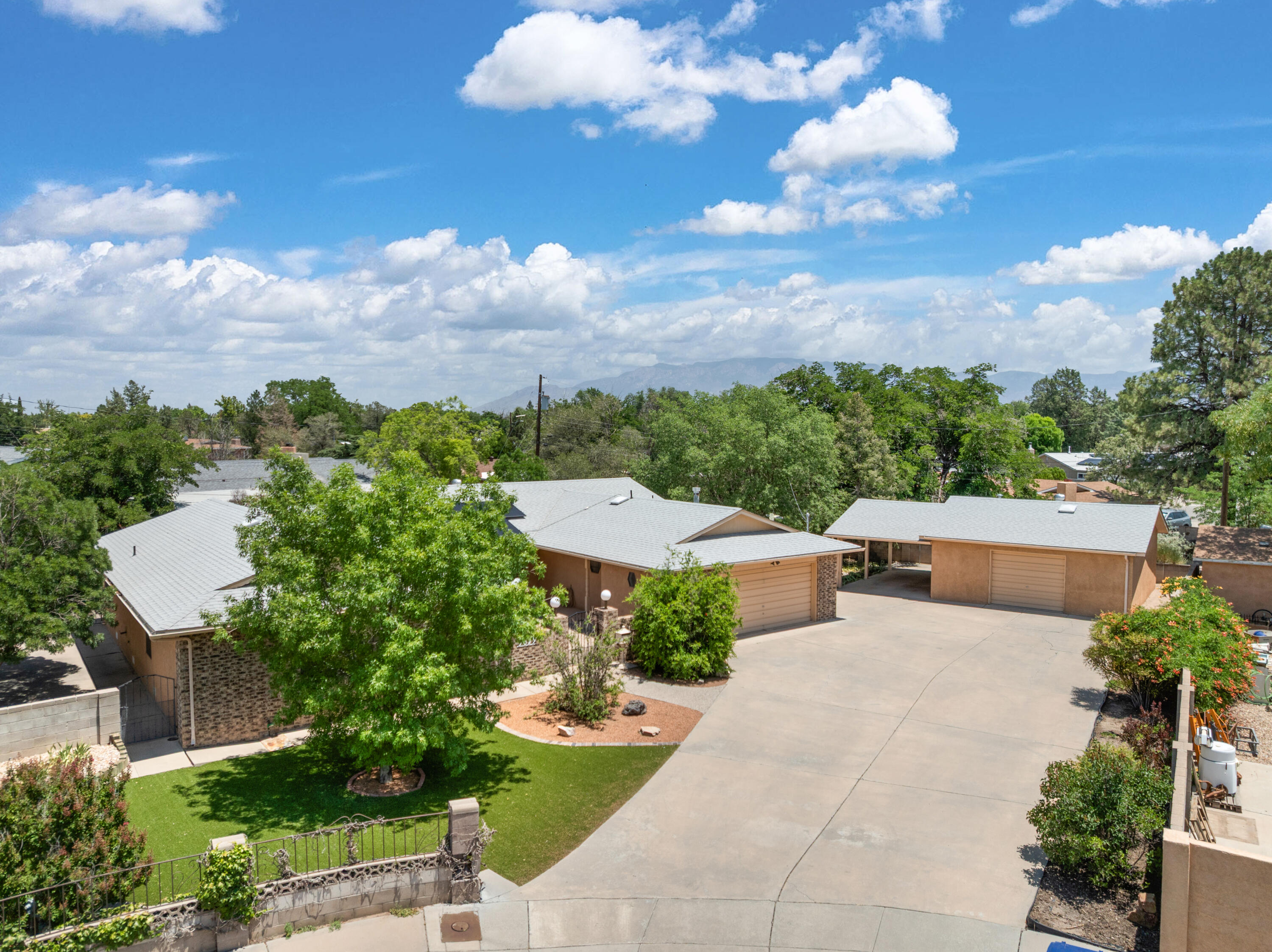 Custom Ranch Style brick home with an extra garage/workshop and a carport on a cul-de-sac.  Over 2370 sf of quality living. Formal living room, family room that opens to a large kitchen with bar and dining area. Huge service/craft room. Primary bedroom with large 3/4 bath and closets, 2nd bedroom, and a 3rd  bedroom with built in cabinetry.  This home sits beautifully on the large lot. Private courtyard entry, fabulous yard, perfect for entertaining and low upkeep. Solar is paid for, refrigerated air, radiant baseboard heat. This home is very special and a great place for you to call home!