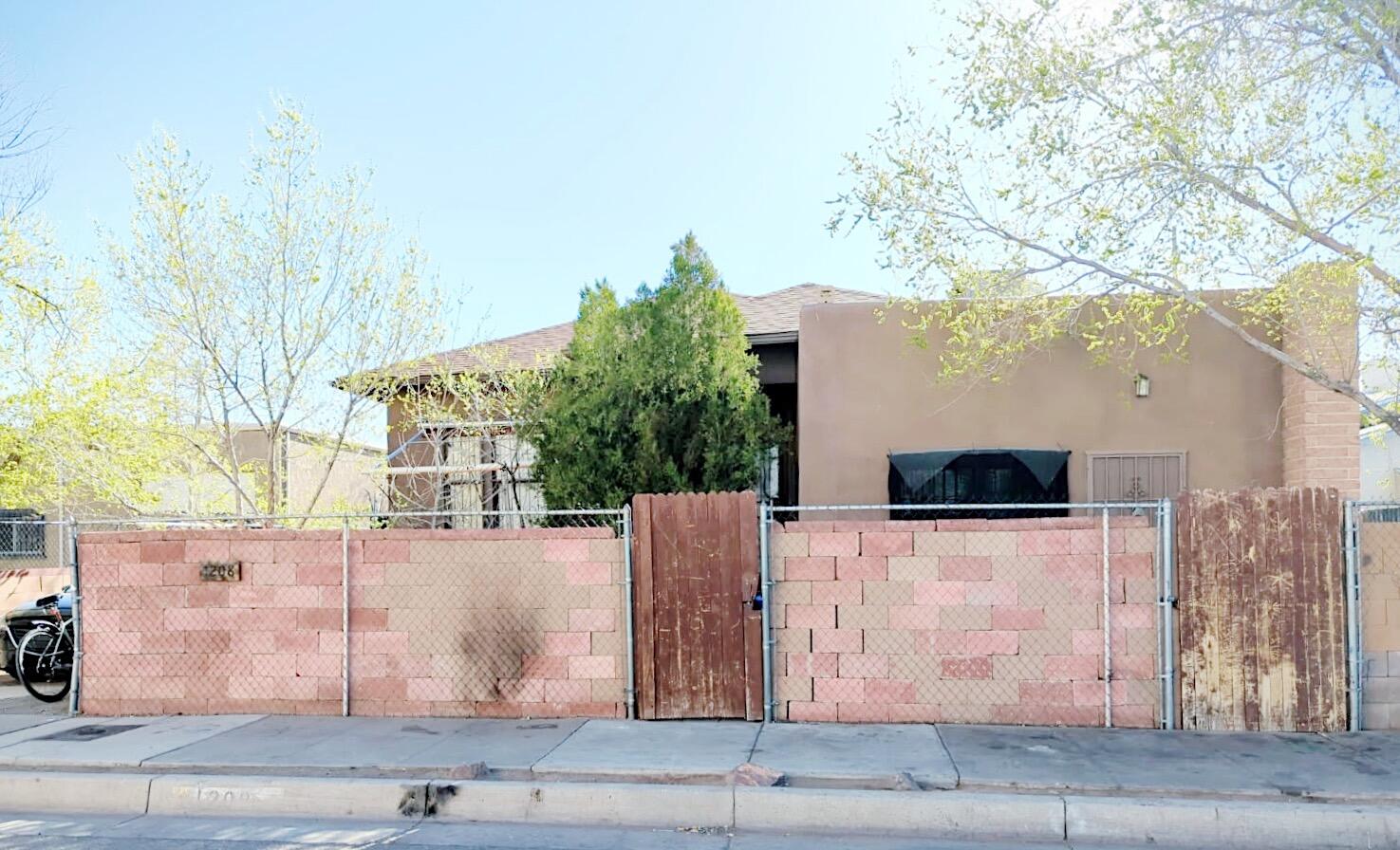 Great Home with great potential!! Mixed Use Zoning for residential/business. Needs a creative mind and willing to accept property the way it sits. As Is. Newer Roof & Stucco. Motorized front gate. Hardwood Floors. Backyard Access. Home is adobe with several cracks in walls. Close to Downtown, Sawmill District, & Old Town. Cafes and Breweries at your fingertips. Just needs some love and attention.