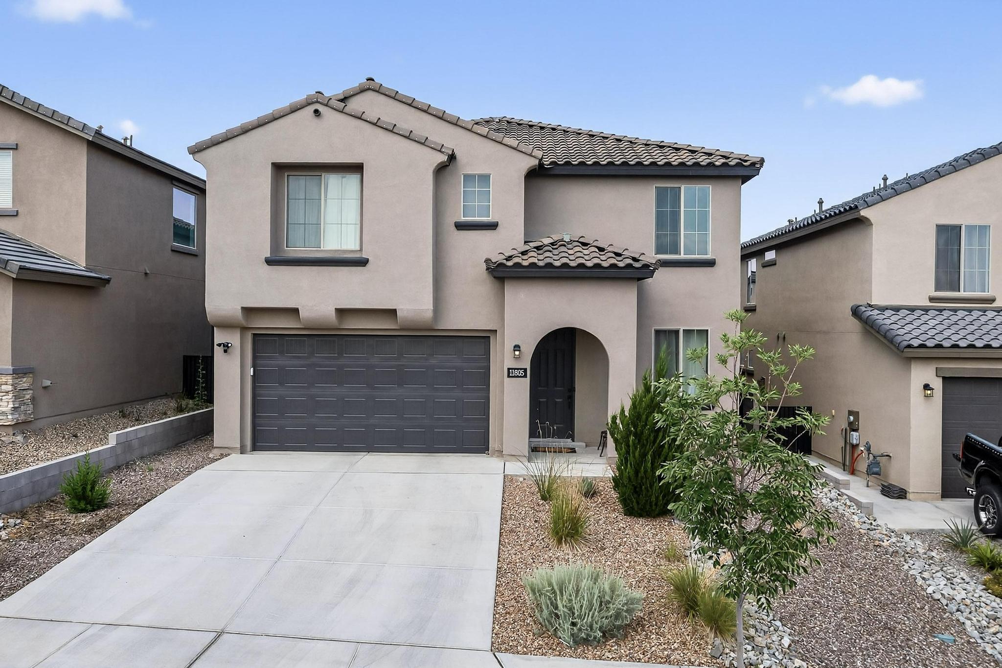 Welcome to 11805 Badger Mountain Trail NW, Albuquerque, NM.Located in the desirable gated Inspiration community, this beautifully maintained home features 4 spacious bedrooms, 2.5 bathrooms, and a 2-car garage. Secondary suite upstairs has its own private bathroom (not shown on floor plan).  A versatile flex room offers the perfect space for a home gym, second living area, or potential 5th bedroom.Step inside to tile flooring throughout the main living area, and a stylish kitchen complete with espresso-stained cabinets, granite countertops and stainless steel appliances. With a thoughtful layout and modern finishes, this home is move-in ready!