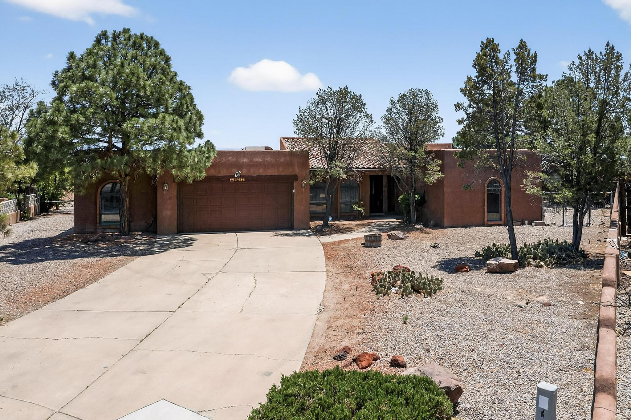 BREATHTAKING VIEWS! This lovely home has 3 bedrooms with an office/family room or studio. The living room has built in shelves, tongue and groove ceiling, exposed adobe, a beautiful kiva fireplace that opens to the covered patio that has panaramic views of the city. The kitchen and breakfast nook have views of the city as well. There is a large pantry, a formal dining room and a laundry room. The large master suite has two closets, double sinks, vanity, separate shower and tub. The two bedrooms are on the other side of the home that provides privacy. The yard is on an extra large lot with .4 acre with backyard access. Some of the extra features are wood windows, skylights, extra long driveway with the workshop that is attached to the garage. Centrally located for convenience.