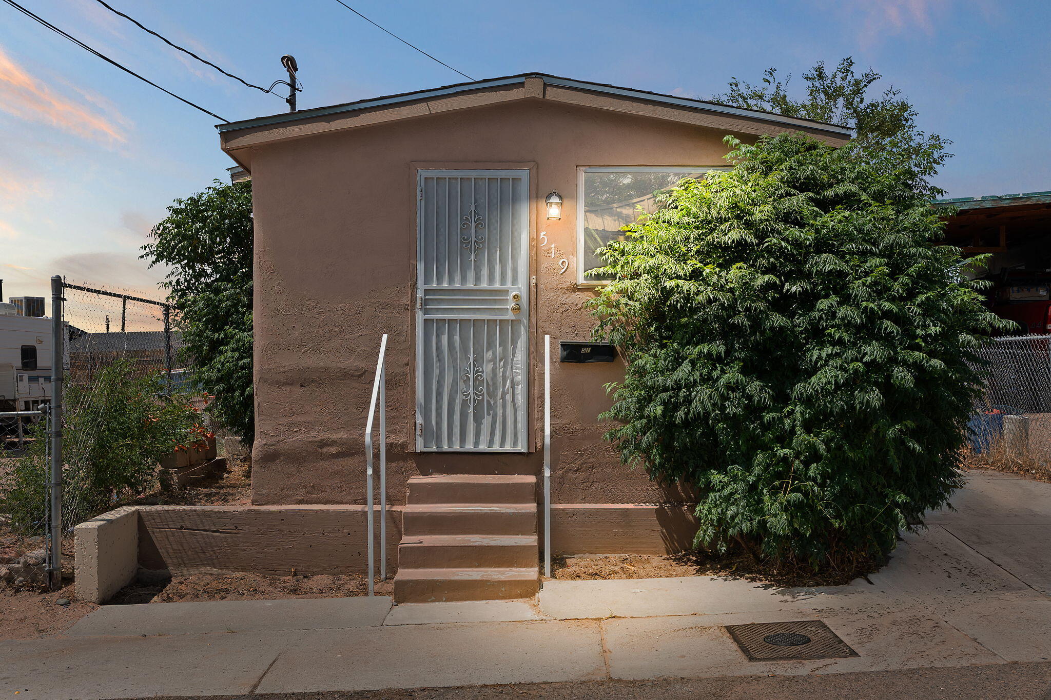 Built in 1936, this delightful 3-bedroom, 1-bath home is full of vintage charm. A welcoming front entry opens to a cozy living room and a separate dining area, both featuring classic details that create a warm, inviting atmosphere. The kitchen offers a practical island and comes fully equipped with all appliances, including a washer and dryer, making the home truly move-in ready. Tile flooring throughout adds durability and ease of maintenance. Enjoy a charming side patio perfect for outdoor gatherings. With an efficient layout and plenty of character, this home is perfect for anyone seeking a space with personality. Just minutes from shops, restaurants, and everything downtown has to offer, it's a wonderful opportunity to own a piece of Albuquerque history in a convenient location.