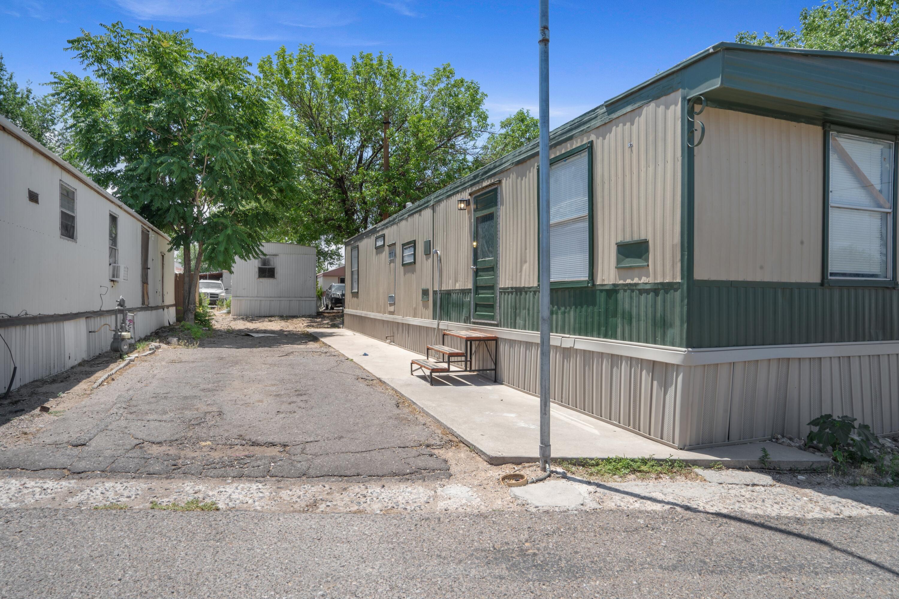 Cozy and updated 2-bedroom, 1-bath single-wide mobile home, in a conveniently located community with a pool. Enjoy vinyl flooring throughout and individual window A/C units in each room to keep you cool all summer long. This well-cared-for home is perfect for anyone looking for a comfortable place to call home, or an investor wanting to add to their portfolio. Schedule your showing today!