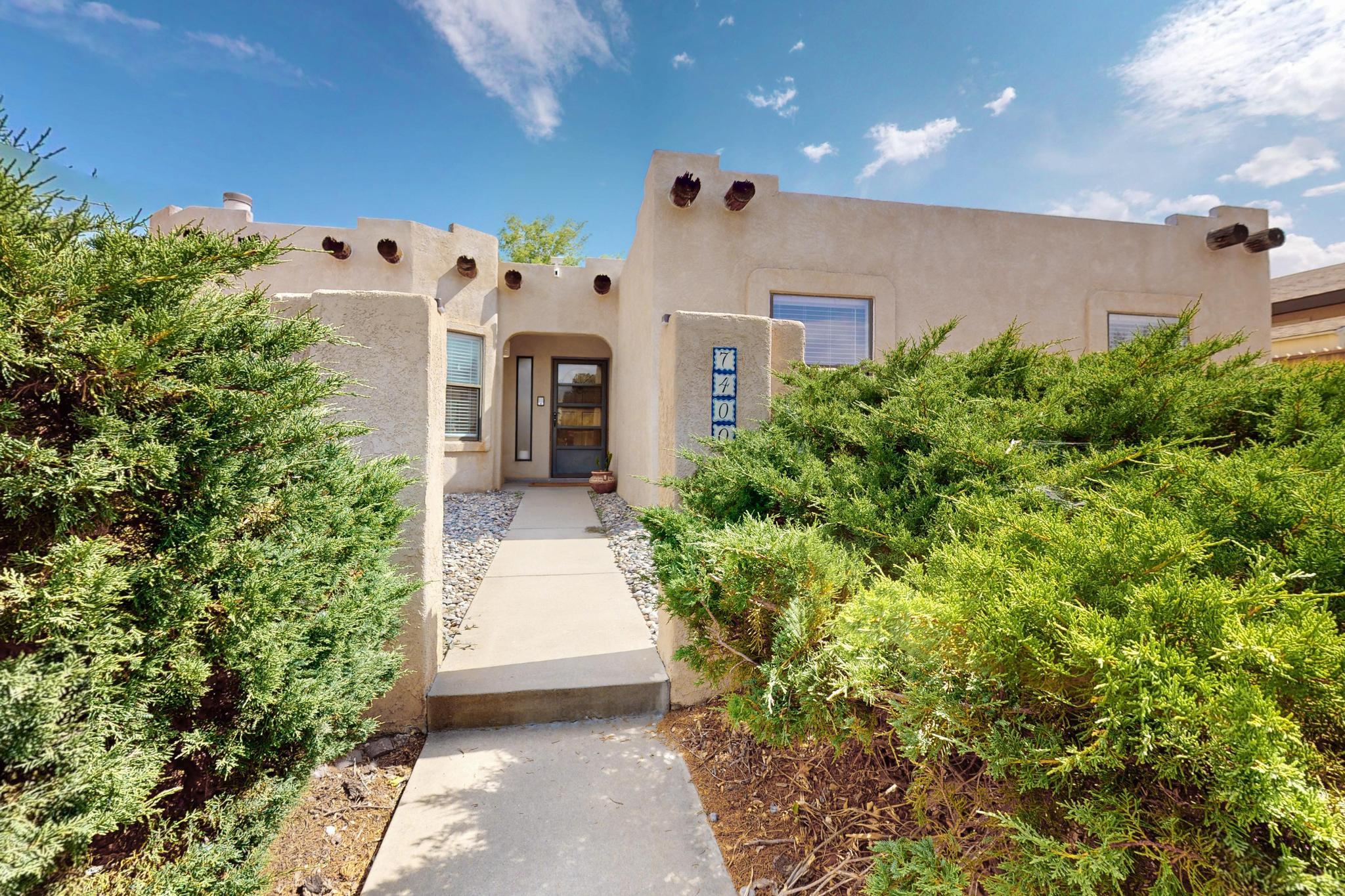 Charming Adobe Style retreat in highly desired Laurelwood subdivision on Albuquerque's northwest side! Welcome to your dream home or lucrative investment opportunity in one of Albuquerque's most picturesque neighborhoods! This stunning, 3 bed 2 bath home blends southwest charm with modern elegance, offering a perfect balance of comfort and style. Fully furnished and operating as a highly successful short-term rental, this turnkey property stays booked year round, making it an ideal choice for homeowners or investors alike. Step inside to discover an open concept living space bathed in natural light, thanks to strategically placed skylights that enhance the warm, earthy tones of the home. The recently updated interior boasts fresh paint, sleek new flooring, and a seamless flow that exudes