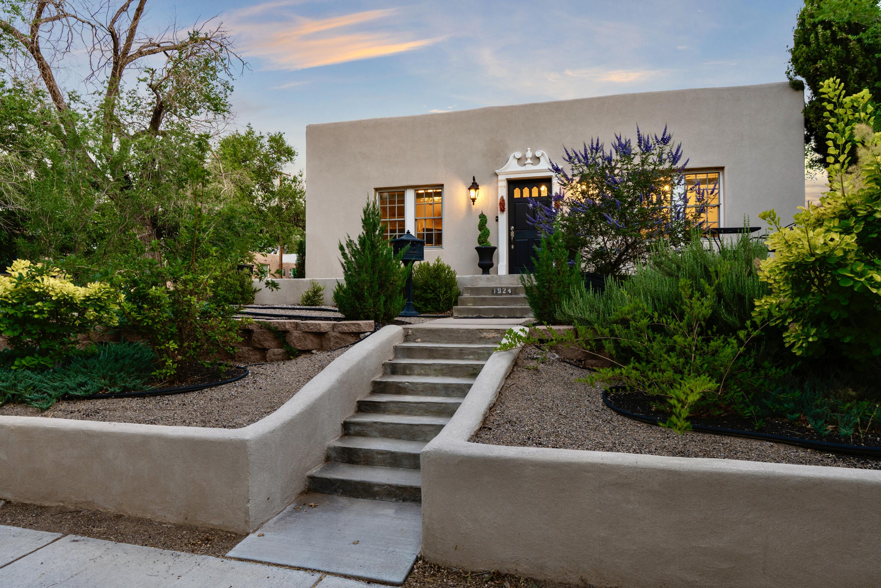 Tucked along the canopy of tree-lined Silver Avenue and iconic Bicycle Boulevard, this timeless home blends vintage elegance with modern refinement. A grand entry with ornamental molding and lantern sconces sets a stately tone. Every inch of this home has been thoughtfully updated, featuring granite countertops, tankless water heater, refrigerated air, electrical, plumbing and a newer TPO roof. Inside, detailed Victorian-style ceiling medallions, elegant wainscoting, and rich hardwood floors create warmth and sophistication. The backyard unfolds into layered entertaining spaces, multiple alfresco dining areas, a covered swing and a detached studio- heating and electric- ideal for creative work or refined storage. Discreet gated entry leads to private parking. Located near Nob Hill and UNM