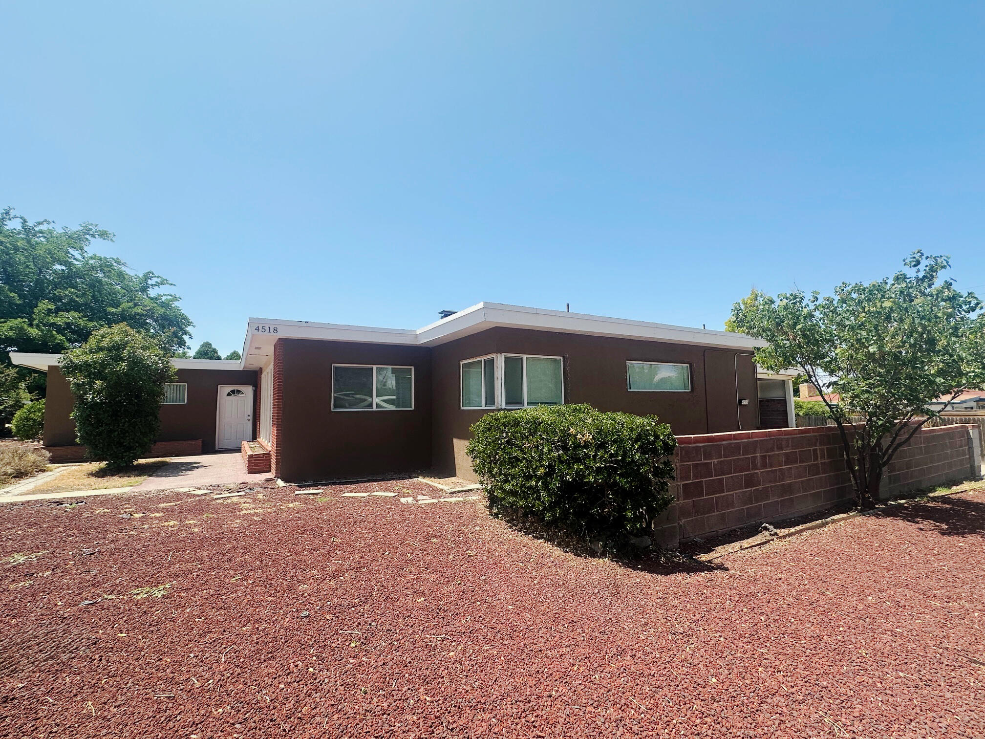 This centrally located property is move-in ready and close to UNM and Nob Hill. The interior is open and light filled. Large living space with a fireplace. Spacious kitchen with island and ample storage space. Two bedrooms and two bathrooms; there are also two rooms that could be additional bedrooms. Out back you will find a covered patio and a storage area. Some recent updates include new flooring and fresh paint. Your new home awaits you!