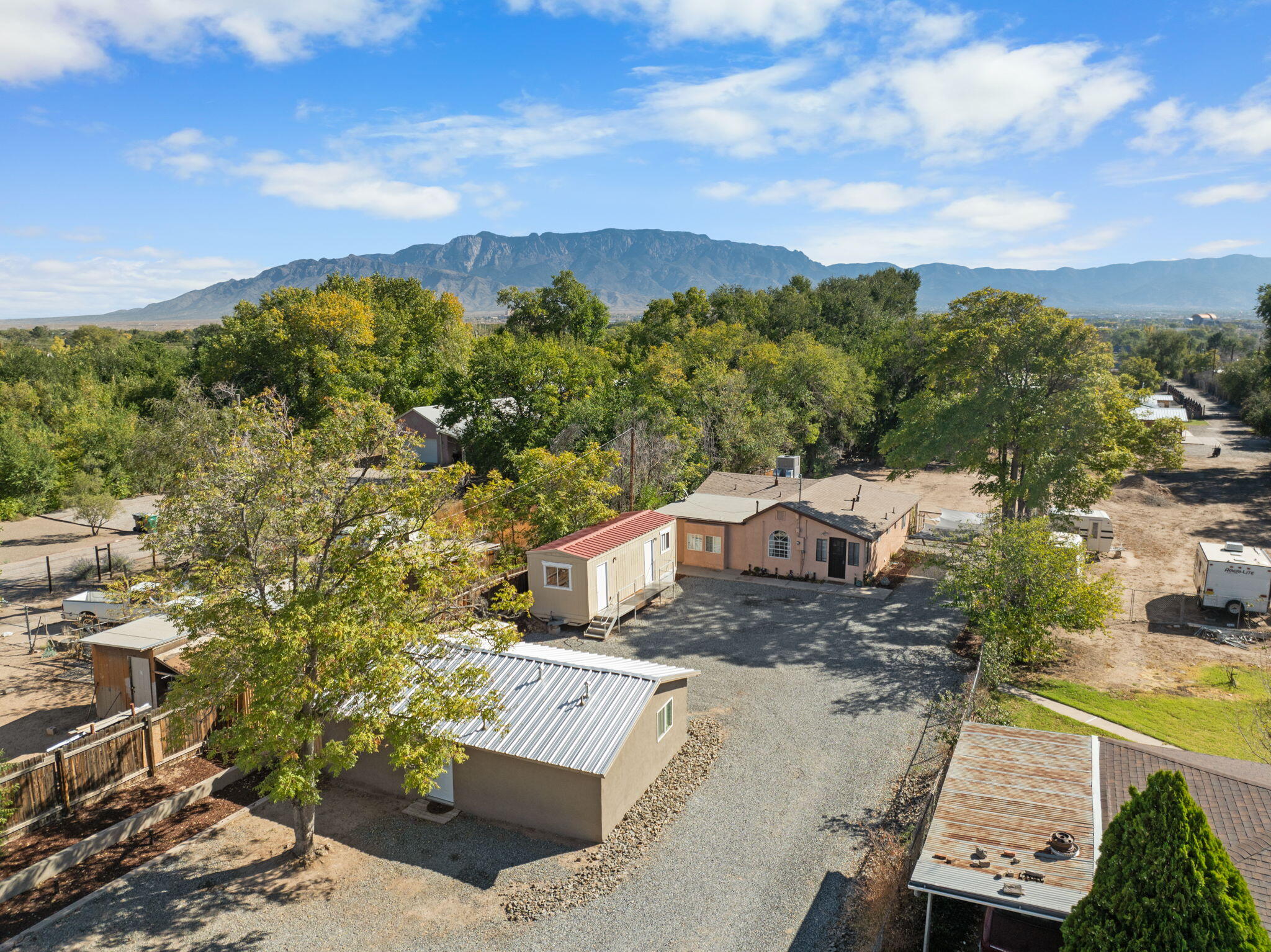 Tucked away in the highly desirable North Valley, this flexible property offers lifestyle and income potential. The main home features 3 bedrooms, 2 baths, an office, and a detached casita--ideal for Airbnb, VRBO, or extended family. A separate workshop and original front structure with water, sewer, and gas stub-outs offer even more opportunity for expansion or rental income. Set on a generous 0.5-acre lot, there's room for gardening, animals, and RV storage--all in a peaceful setting. Whether you're an investor or seeking multi-generational living, this rare find delivers versatility and value in one of Albuquerque's most sought-after locations. Schedule your showing today!