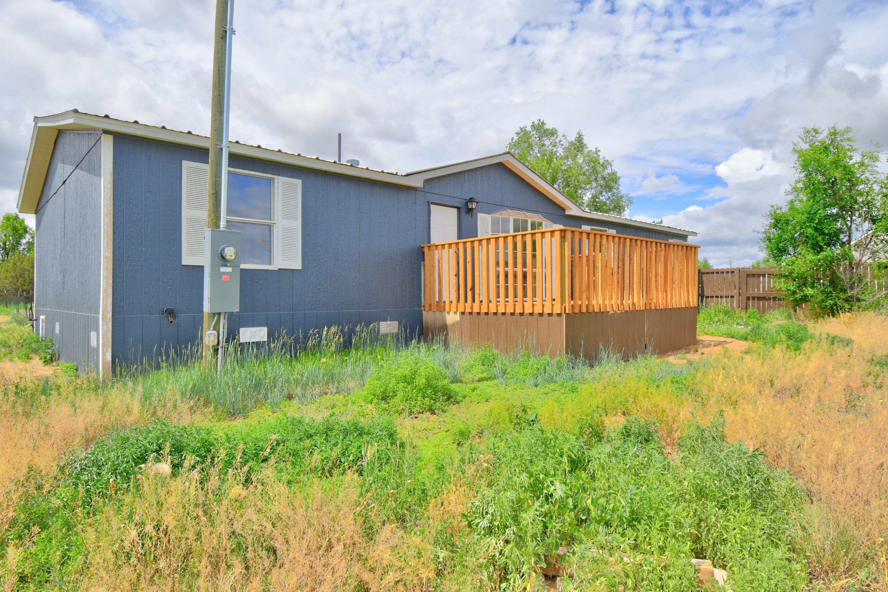 Welcome to this 3-bedroom, 2-bath manufactured home situated on a spacious corner lot with convenient side access. Step inside to a light-filled, open-concept great room--perfect for relaxing or entertaining. The remodeled kitchen features updated cabinetry, modern appliances, and a functional layout that flows seamlessly into the formal dining area. The private master suite is complete with a tub and a separate shower. Two additional bedrooms and a full bath provide ample space for family, guests, or a home office. Enjoy outdoor living on the brand-new deck, ideal for summer barbecues or quiet mornings. Additional highlights include a durable metal roof, a brand-new air conditioning system, and proximity to local schools and shopping for ultimate convenience.