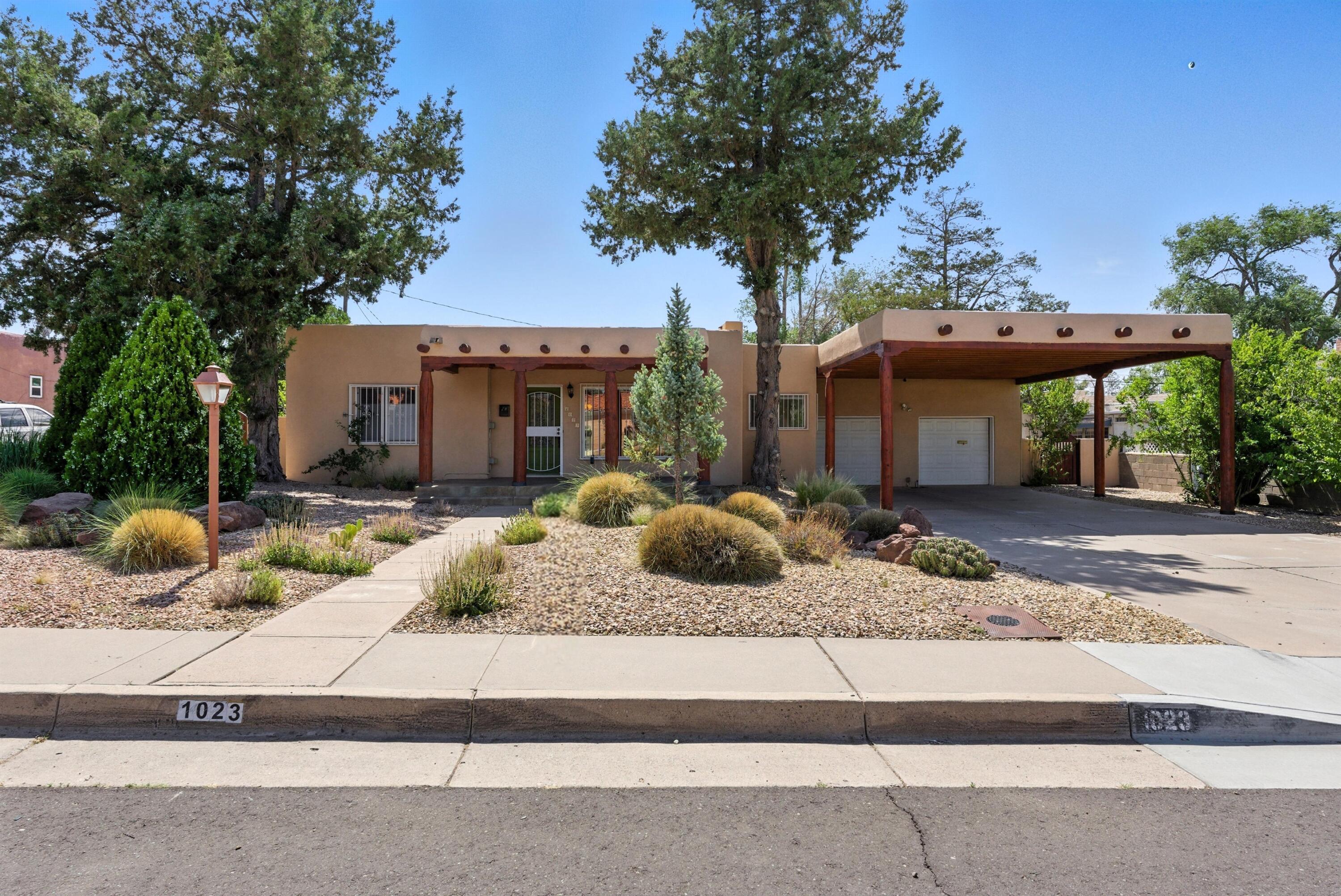 Wow! You'll love this beautiful and tasteful southwestern home full of color! Enter beneath the grand portico with massive hand-hewn columns and rustic vigas, to find an explosion of terracotta hues blended perfectly with shades of turquoise,  muted greens and dusty yellows. An expanded floorplan flows nicely through the bright and whimsical kitchen and culminates in a beautiful primary suite with soaring ceilings and room for a private seating/reading area. Check out the colorful glass kitchen backsplash with custom matching refrigerator and light fixtures! Upgraded cabinets with tons of storage plus refrig a/c, recent tankless water heater, paid-off solar, and an oversized 2car garage! If you're going to live in the southwest, go big! Come see this beautiful one-of-kind home!