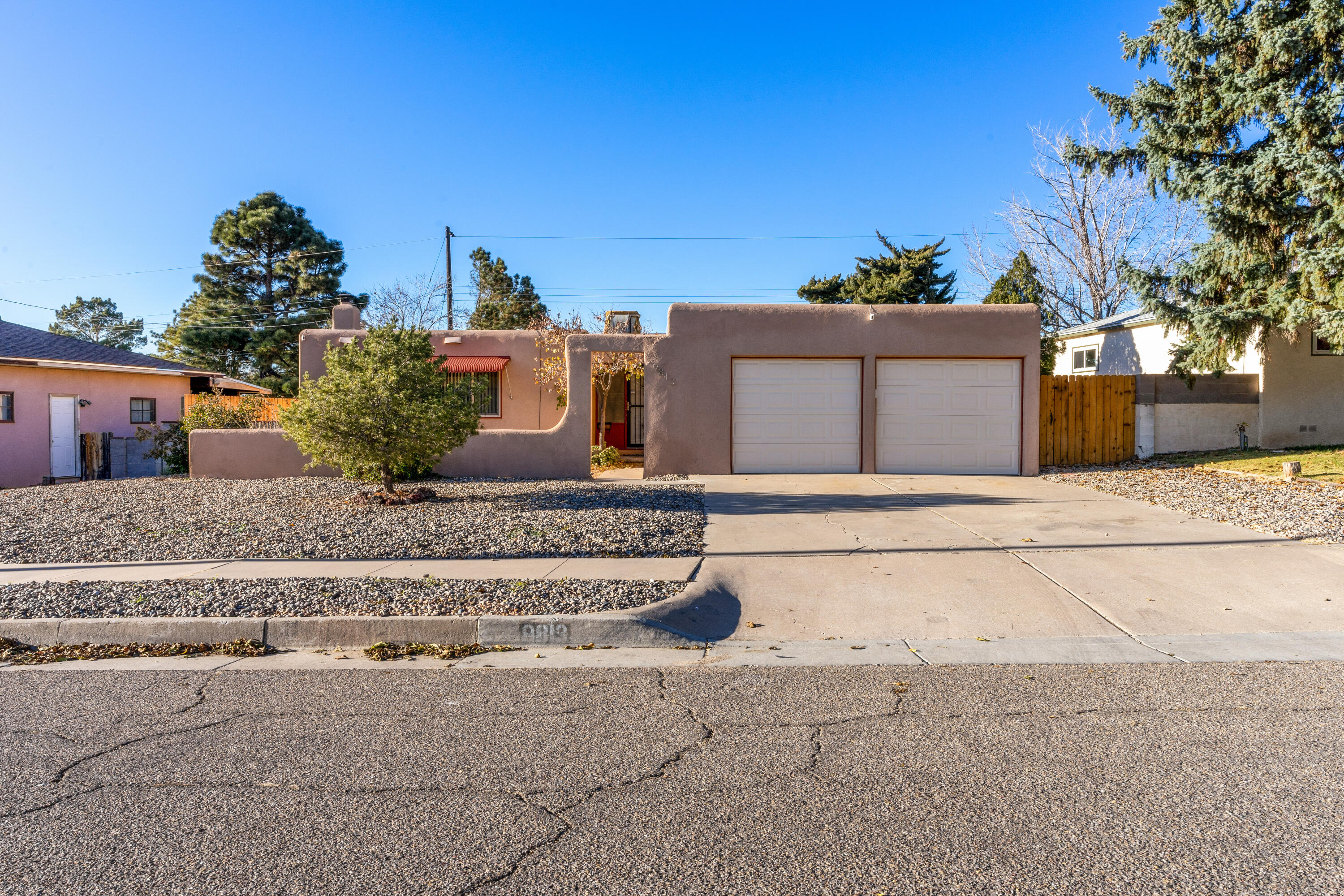 Welcome to this beautiful home in a great NE Heights location.  This lovely home features hardwood floors, vinyl windows and both bathrooms were remodeled in the last couple of years.  Large living area features a brick fireplace, and you'll love the open kitchen / dining area as well.  Check out the professionally landscaped backyard with paver stone patio, syn-lawn, and xeriscaping throughout.  Other recent improvements include a newer furnace and master cool unit.  Wow this home has had so much done to it and shows great.  Come see this move in ready home today.