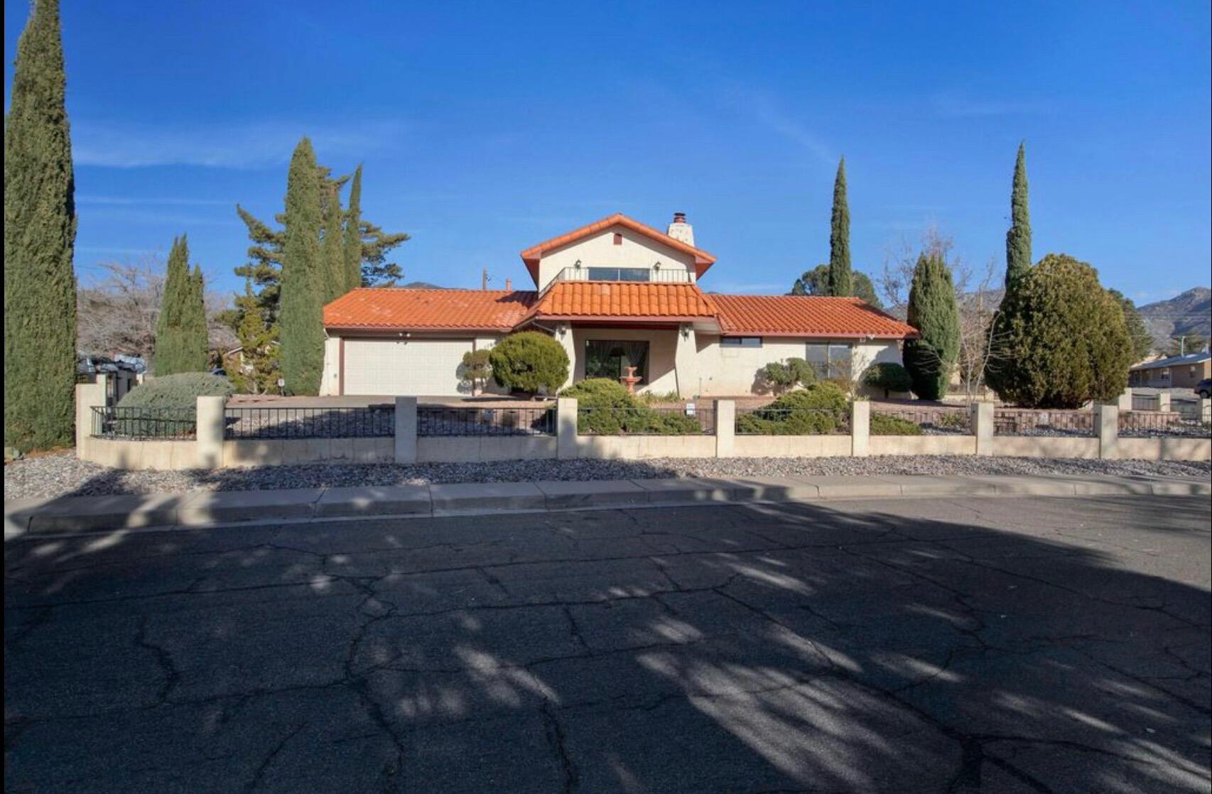 Stunning Mediterranean-style home on a spacious corner lot! Enjoy a classic tile roof, two generous living areas, fireplace and an updated kitchen. Entertain with ease in the outdoor kitchen or relax in the beautifully landscaped backyard. Ample parking includes an attached garage, RV pad, and a rare second driveway--perfect for all your vehicles and toys. With 3 bedrooms, 2 baths, this home offers comfort, style, and flexibility. Easy commute to KAFB and Labs.