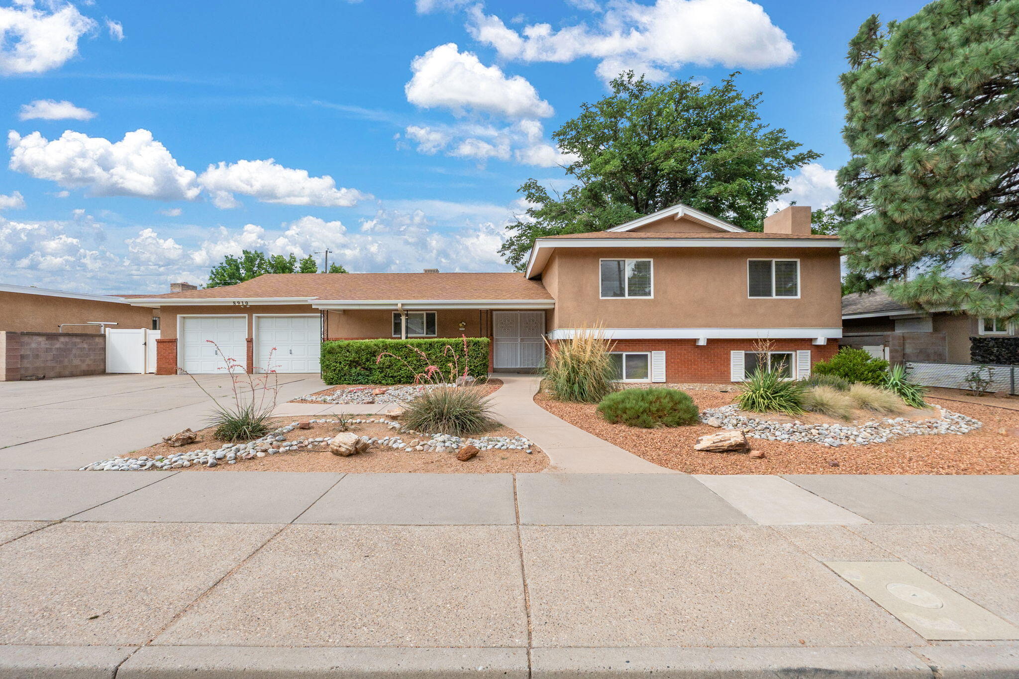 Welcome to this lovely Tri- level, 3 up,1 down. Features a formal dining/living area, 15X26 game room/ den w/fireplace, new flooring, down. Light & bright great room AKA Sunroom, with vaulted ceilings, gas/log FP, skylights, overlooking a GARDENER'S DREAM backyard with blooming flowers from Spring until Fall, mature landscaping with a peach tree, daffodils, roses, and tulips, covered patio and much more. Long galley kitchen with abundant oak cabinets, pull outs, island, new appliances, office nook. RV PARKING! The oversized garage provides space for workshop.  Roof(8years), 2 evap. units (13years), water heater (4 years) Stucco (3 years), fresh paint in rooms and trim.  INSPECTION completed, repairs done! Sandia High School, walking distance to Bellehaven Elementary. Don't miss out!!