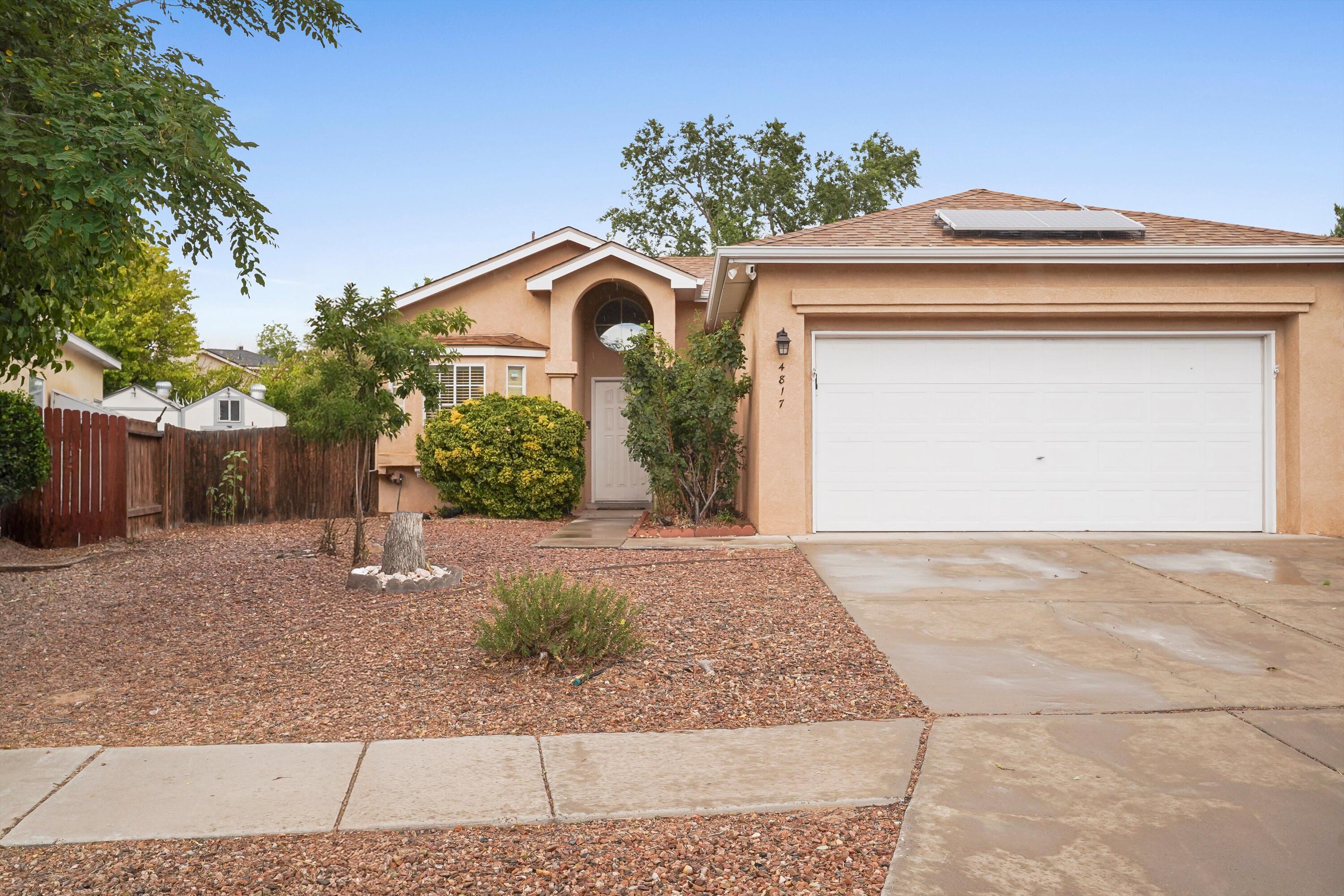BASK IN SUNLIGHT AND SPACE IN THIS INVITING TAYLOR RANCH GEM with SOLAR! Soaring ceilings and oversized windows flood the open living space with natural light, while a cozy fireplace anchors the living room for quiet evenings. The efficiently designed kitchen offers just the right amount of space, complete with a pantry and seamless flow into the main living area. The spacious main bedroom offers both a tub and separate shower for relaxing nights in. Step into the backyard and pick apples or peaches right off your own trees. Enjoy the comfort of refrigerated air, a large two-car garage, and the bonus of solar panels . Come see what it feels like to live light-filled and worry-free.