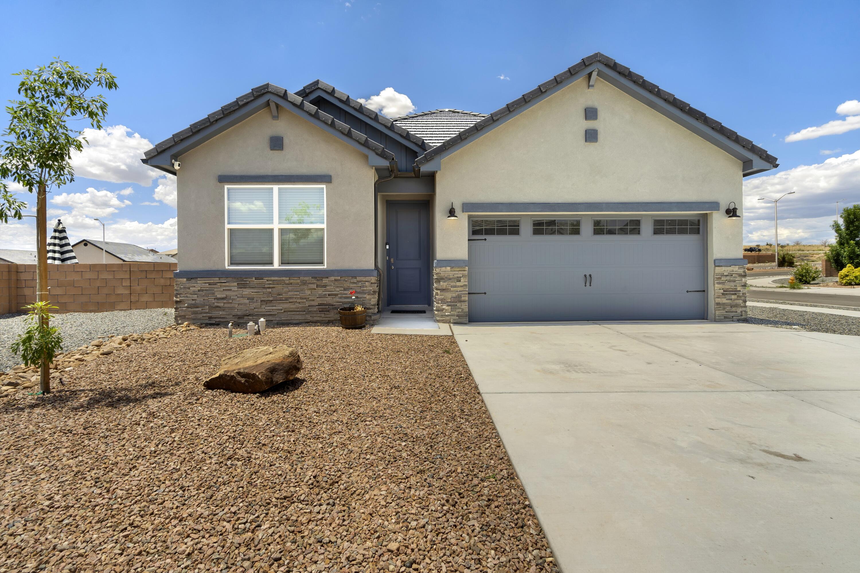 Welcome to 6904 Pina Way NE in Rio Rancho! This beautifully landscaped and modern home, built in 2022, features an open layout, updated finishes, and a spacious backyard with stunning views of the Sandia Mountains. Located in a quiet neighborhood with easy access to parks, schools, and shopping, it's the perfect mix of comfort and convenience. Enjoy peaceful living with no rear neighbors and breathtaking sunsets every evening.