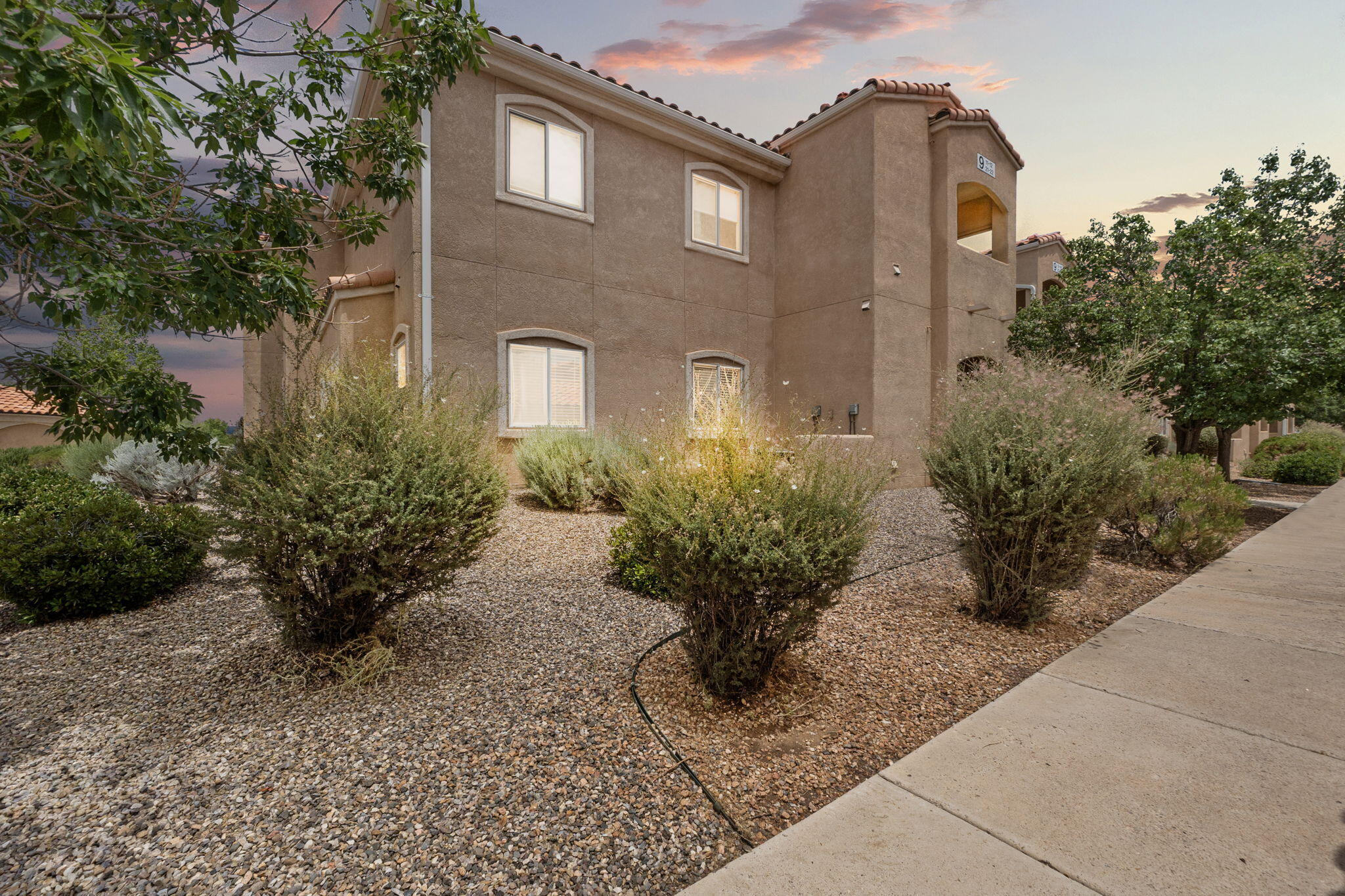 Welcome to this updated condo in the desirable Rancho Mirage.  Located in a gated community in the heart of Albuquerque! Fresh paint and brand-new trendy flooring create a clean, modern feel. The kitchen features stainless steel appliances, a sleek backsplash, recessed lighting, and ample cabinet space. Enjoy year-round comfort with ceiling fans, a newer water heater, and refrigerated air. Washer and dryer convey. Relax on your private patio just steps from the sparkling pool! Home includes a full garage and an additional parking space. Community amenities feature two pools, a clubhouse, fitness center, parks, playgrounds, and walking/biking trails with easy access to I-25 and Paseo del Norte.  Well loved and move - in ready!  Don't wait, call today to schedule your private showing!