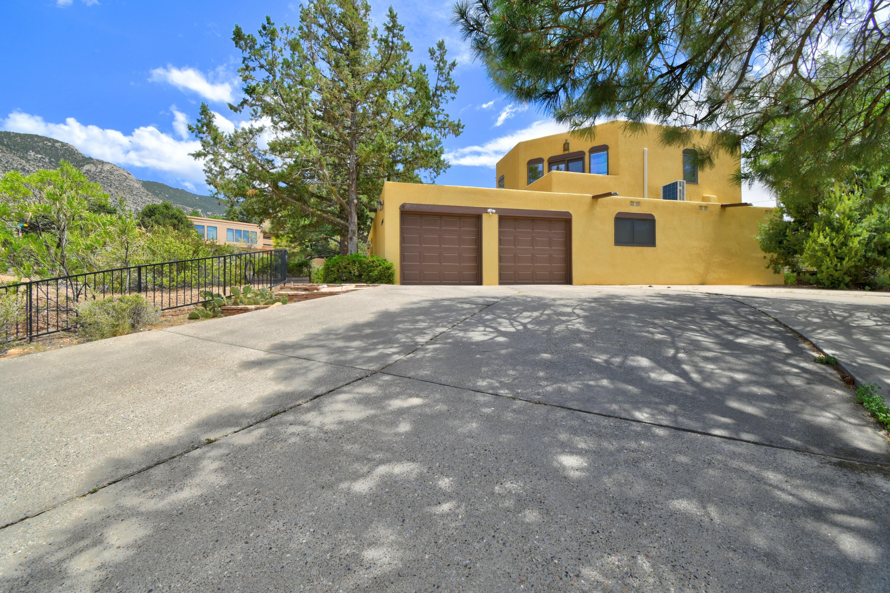 Open house Sunday 6/29 1-3pm. Located on an oversized corner lot with FOOTHILL VIEWS this exceptional GLENWOOD HILLS home offers both functionality & flexibility. 3/4 bedrooms, 2.5 baths, & potential for a 4 bdrm or guest suite. Light & bright living/dining combo w/built-ins. Pretty kitchen w brkfst area. Large primary suite provides a peaceful retreat. Good sized 2ndary bdrms. Upstairs is a versatile 2nd living area complete with private access to an oversized deck with durable Trex decking. This space could serve as a bonus room/home office/guest suite/or even a 4th bdrm, & features an area for a kitchenette -ideal for multi-generational living or extnded stays. Low-maintenance landscaping, & spacious covered patio. Close to hiking and biking trails, restaurants, retail, & KAFB.