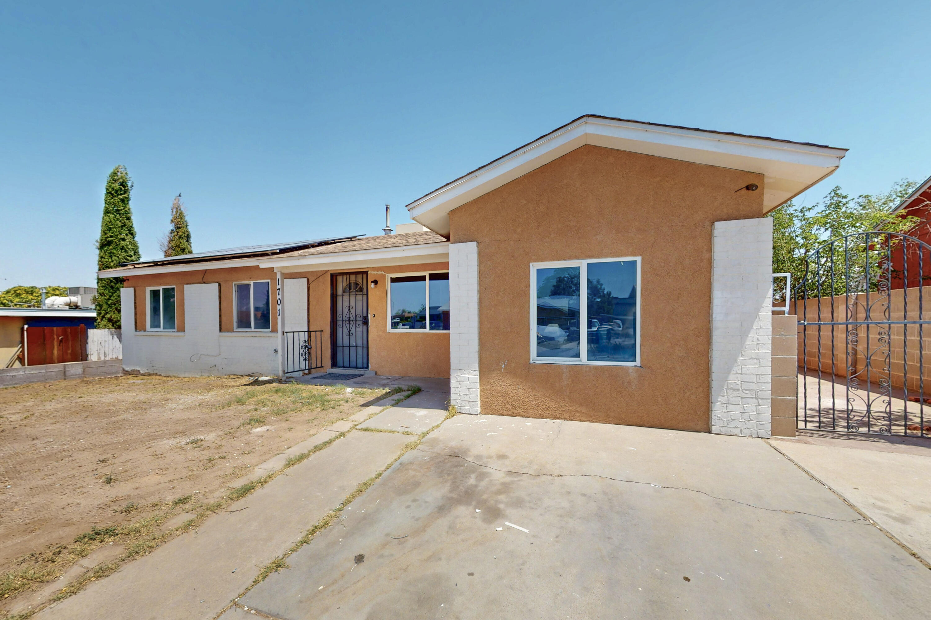 Come view this spacious possible 4-bedroom, 1 Office home located in the UNM area. Enjoy the warmth of the wood stove this winter with your family gathered in the open living area, Easy access to highway, schools and restaurants. Near UNM, Kirtland Air force Base, and walking distance to The Pit and Isotopes Park. Updated cabinets and countertops in the kitchen, heater and cooling system, tile flooring throughout.