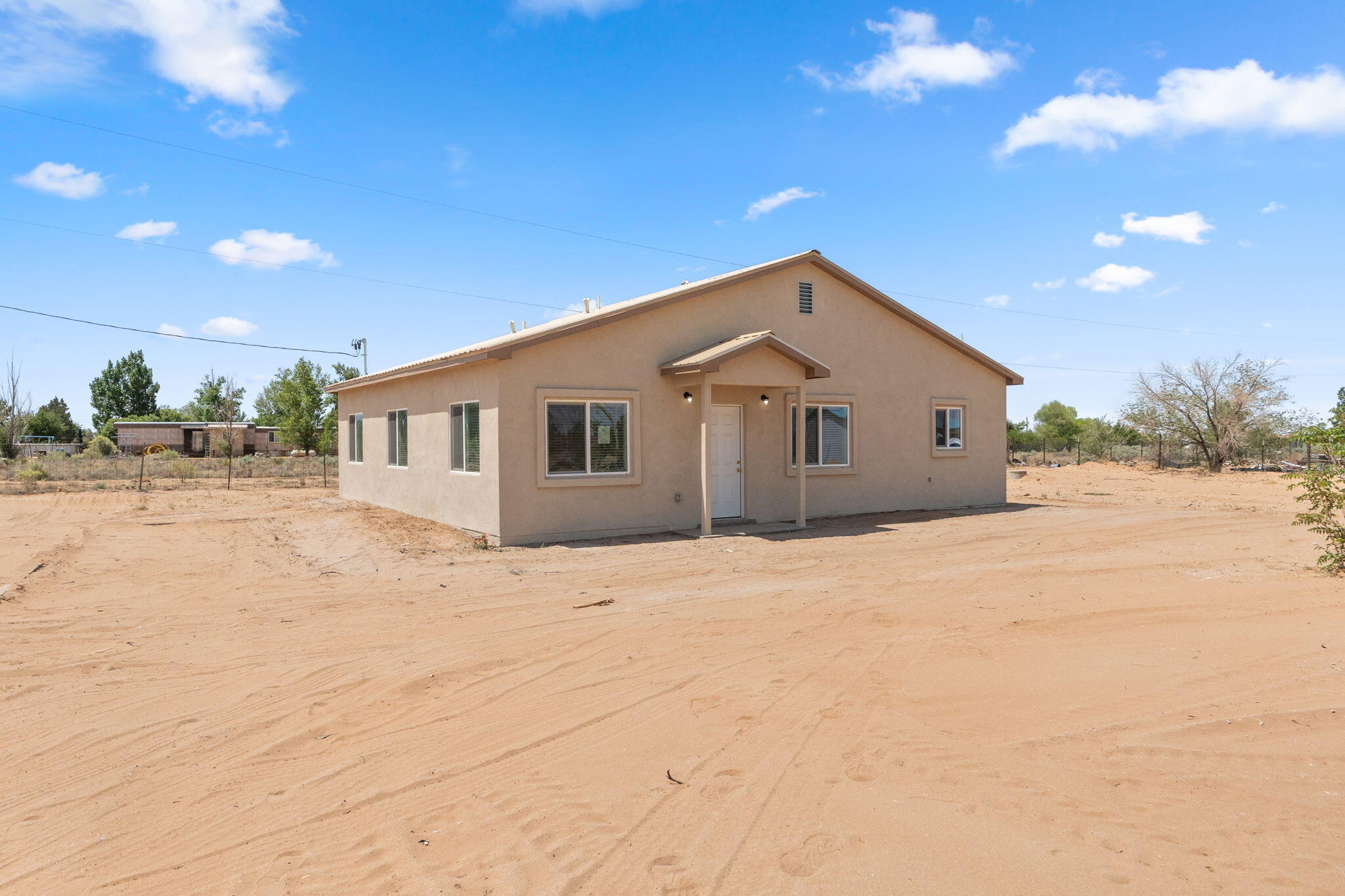 Beautifully situated on 1.35 acres in Los Lunas, this thoughtfully finished single story home offers 3 bedrooms, 3 bathrooms, and an open concept layout designed for modern living. You'll love the light, airy interior with wood style- tile flooring, new white cabinetry, and stainless steel appliances. The virtual staging showcases its full potential. The spacious lot provides endless possibilities room for outdoor living, RV parking, or future projects all in a peaceful setting with room to grow.
