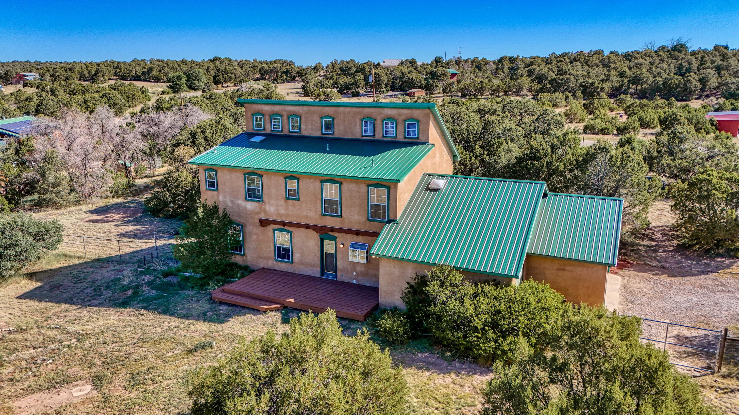 Welcome to East Mountain Living! This home is waiting for you and your family and friends. It is complete with 2 beautiful fenced acres and views of the Sandia Mountains. The interior has nice sized rooms with a huge formal dining room that can be used for a second living area.There is also an office/bedroom downstairs for convenience. The downstairs area has hardwood floors and brick floors in the kitchen. The upstairs area is complete with 3 bedrooms and 2 full baths. There is a nice sized backyard deck to enjoy the evening BBQs with family and friends.There is also a 2 car garage with a attached workshop. Don't let this home get away. Call us for a private showing.