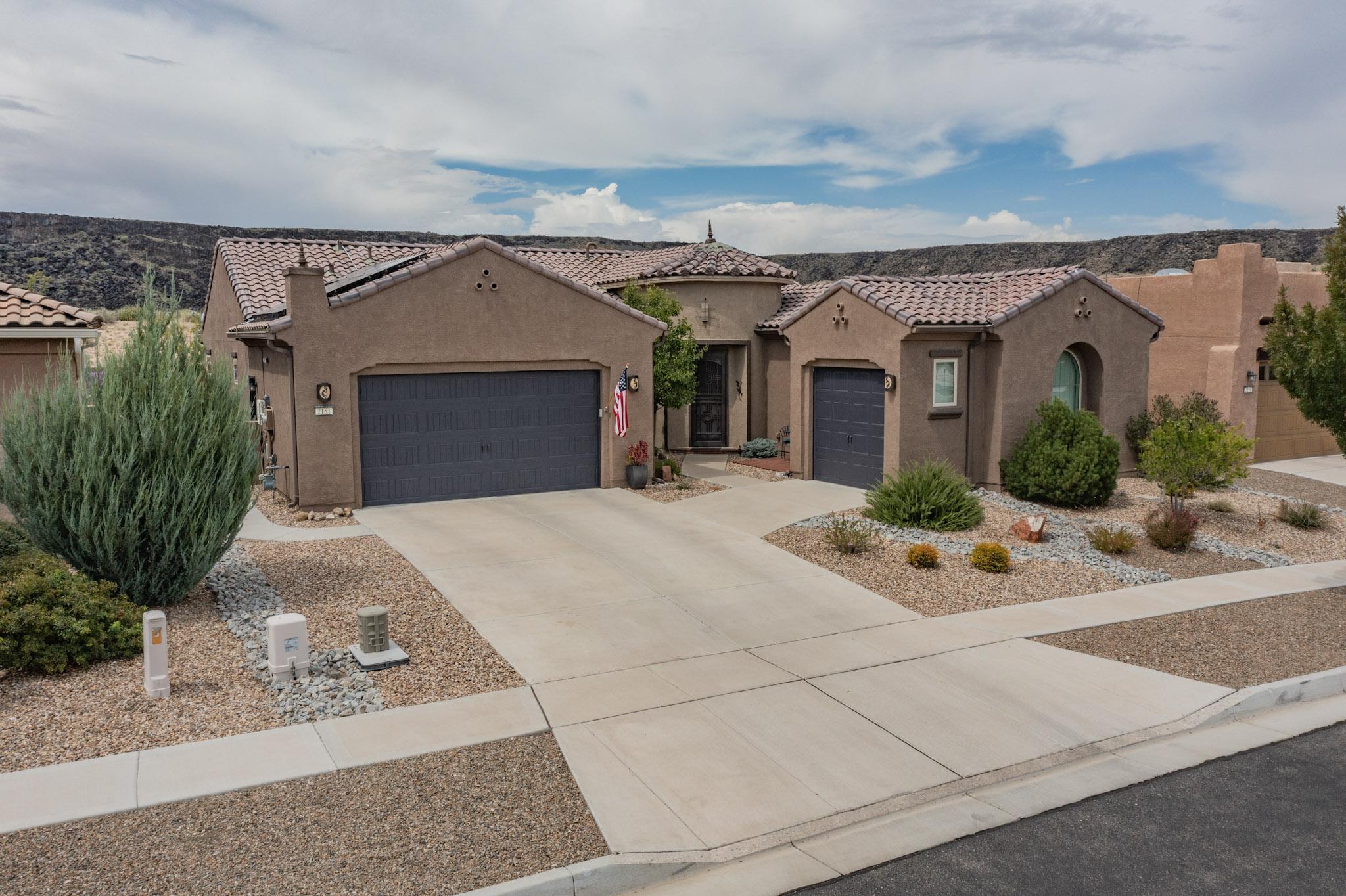 Looking for an opportunity to live in the wonderful 55+ Del Webb Community at Mirehaven? Look no further. This very unique home offers a finished 2 car - plus another 1 car garage, solar panels, and backs up to the Petroglyph's so there will never be any homes built behind you. Front and back yard's are beautifully done and on a fully automatic bubble drip system. Back yard features a soothing water feature plus huge covered porch and Alumawood Lattice patio cover with Rader Awning for added shade. Inside this gorgeous home you will find plenty of space with 3 beds plus an office, huge living area, separate dining room and butler's pantry complete with wine fridge and granite counter top, primary bath offers large shower w/bench, and hall bath that with top of the line jetted walk-in tub