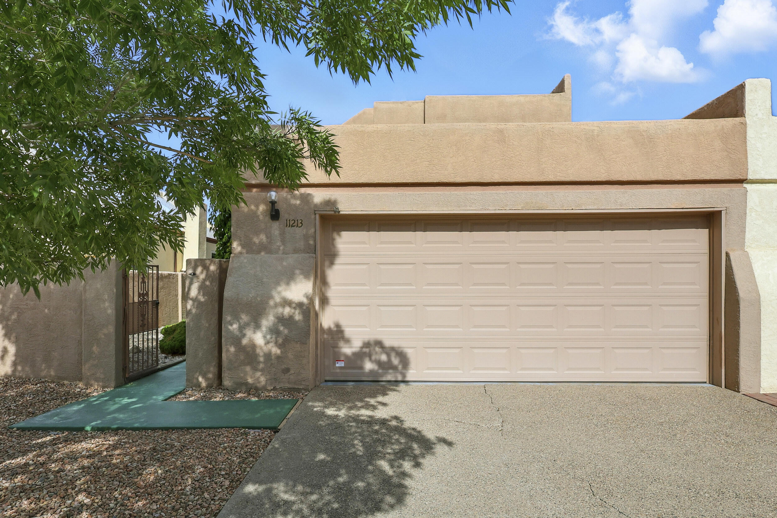 Charming Townhouse with Mountain Views in Coveted Foothills Neighborhood. Welcome to this original and well-maintained 3-bedroom, 2-bathroom townhouse nestled in one of Albuquerque's most sought-after foothills communities. With breathtaking views of the Sandia Mountains and easy access to bear canyon, this home offers the perfect blend of tranquility, charm, and potential. Step inside to discover a spacious and light-filled layout with classic Southwestern character throughout.  The kitchen and bathrooms retain their original charm and offer a fantastic opportunity, modern updates to suit your style, and priced to sell!! Includes a  2-car garage perfect for storage and convenience along with a private outdoor space ideal for relaxing or entertaining under New Mexico's brilliant skies
