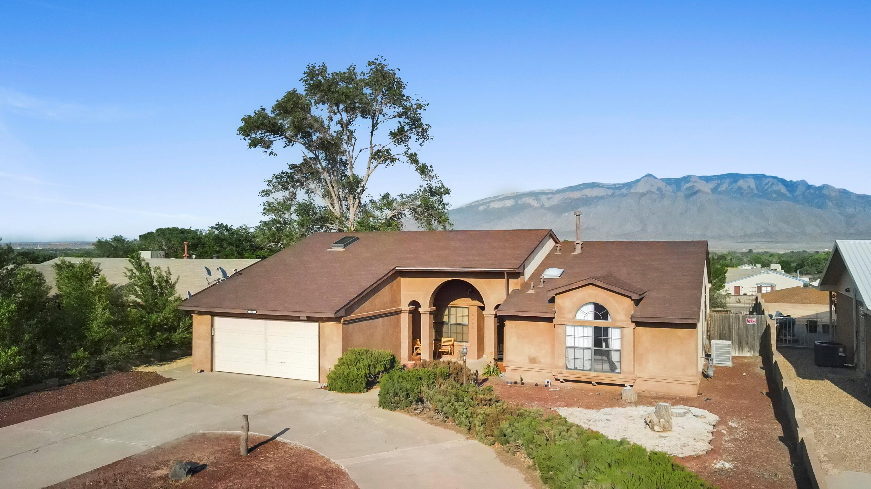 Unmatched Sandia Mountain Views and a Sparkling Pool! This beautifully updated single-story ranch home in Rivers Edge I offers unobstructed mountain views and your very own pool--your personal oasis in Rio Rancho. Filled with natural light, this spacious home is truly move-in ready. Step inside to find two generous living areas, including a formal living/dining room with stunning Palladian windows and a separate family room that flows into the cook's kitchen and cozy breakfast nook--perfect for everyday living and entertaining.The private owner's suite takes full advantage of the views and features a luxurious garden soaking tub. With three spacious bedrooms plus a versatile fourth room ideal for an office, den, or guest space, the layout is flexible and functional. Enjoy peace of