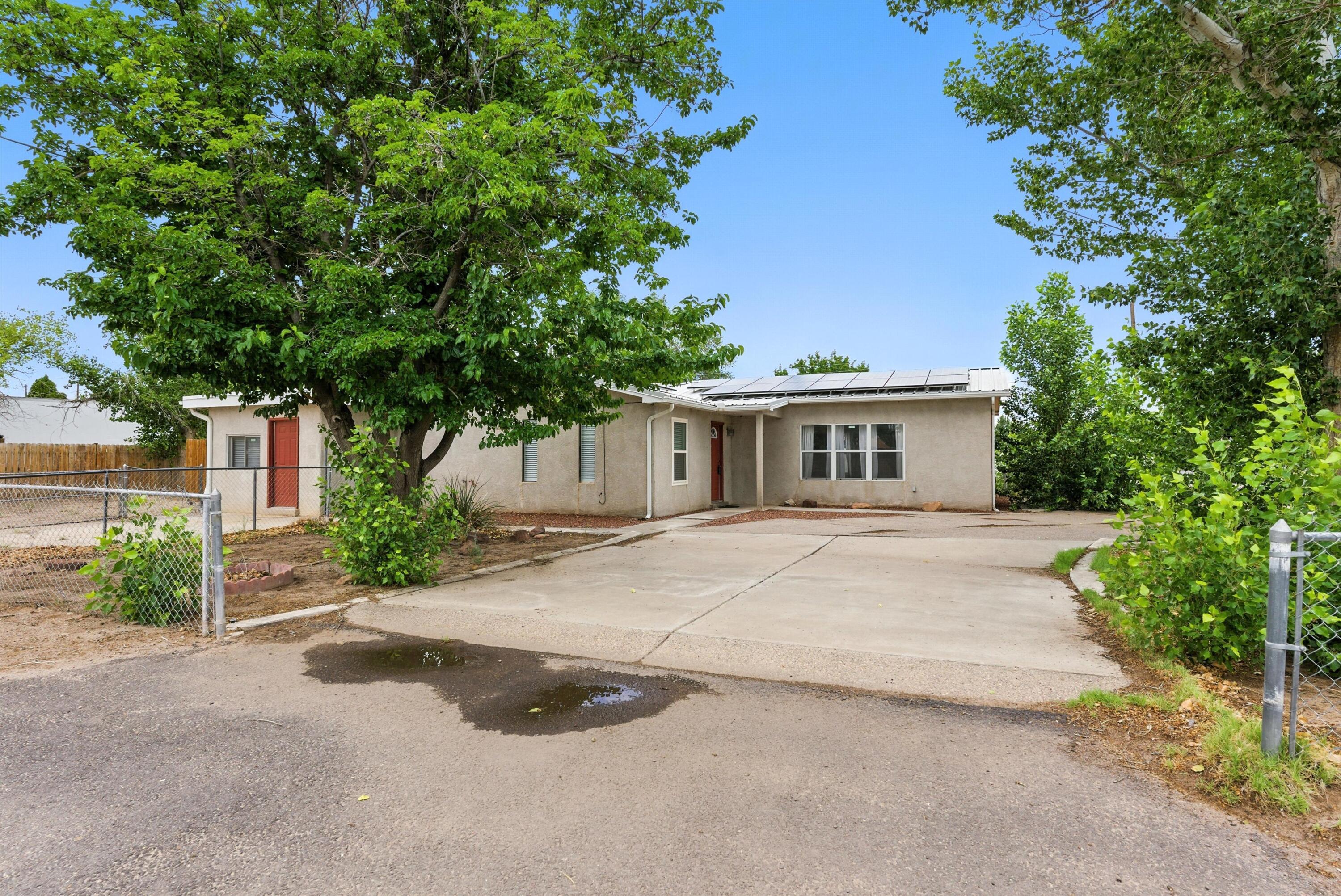 Bright and Happy 4 Bedroom 2.5 bath with an additional separate large guest house, casita, in-law quarters, or additional rental income as it has its own separate parking and entrance, on .66 of an acre. Newer metal roof and paid for solar panels insure low utilities. Private well. Corner lot, fenced and cross fenced. Circular drive. Large family media room for movie night or entertaining. Close to I-25 for quick drive to ABQ, Isleta, or Bosque Farms for shopping, restaurants, breweries and casino.