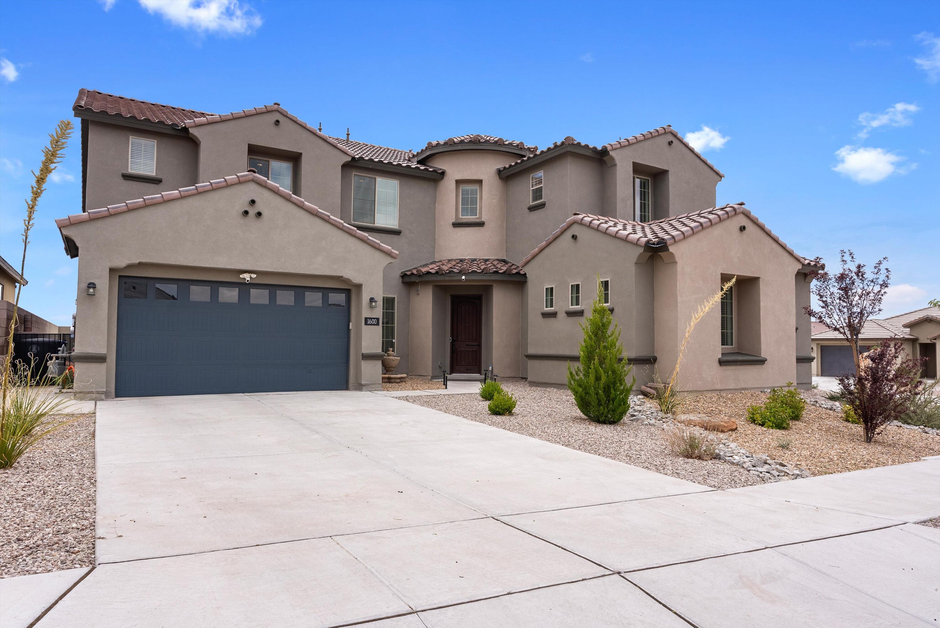 Located in Pulte's newest gated community, Inspiration, with convenient access to many amenities and I-40. This UNIQUE two-story home has ample living space to suit all your needs. Enjoy a formal dining room, chef kitchen, wine chiller, open gathering room, and an upstairs loft perfect for entertaining. Host guests or in-laws to stay in the private guest suite and relax by the patio internal and external sound system, fireplace or on the balcony overlooking the beautiful Sandia's. Solar Panels leased.