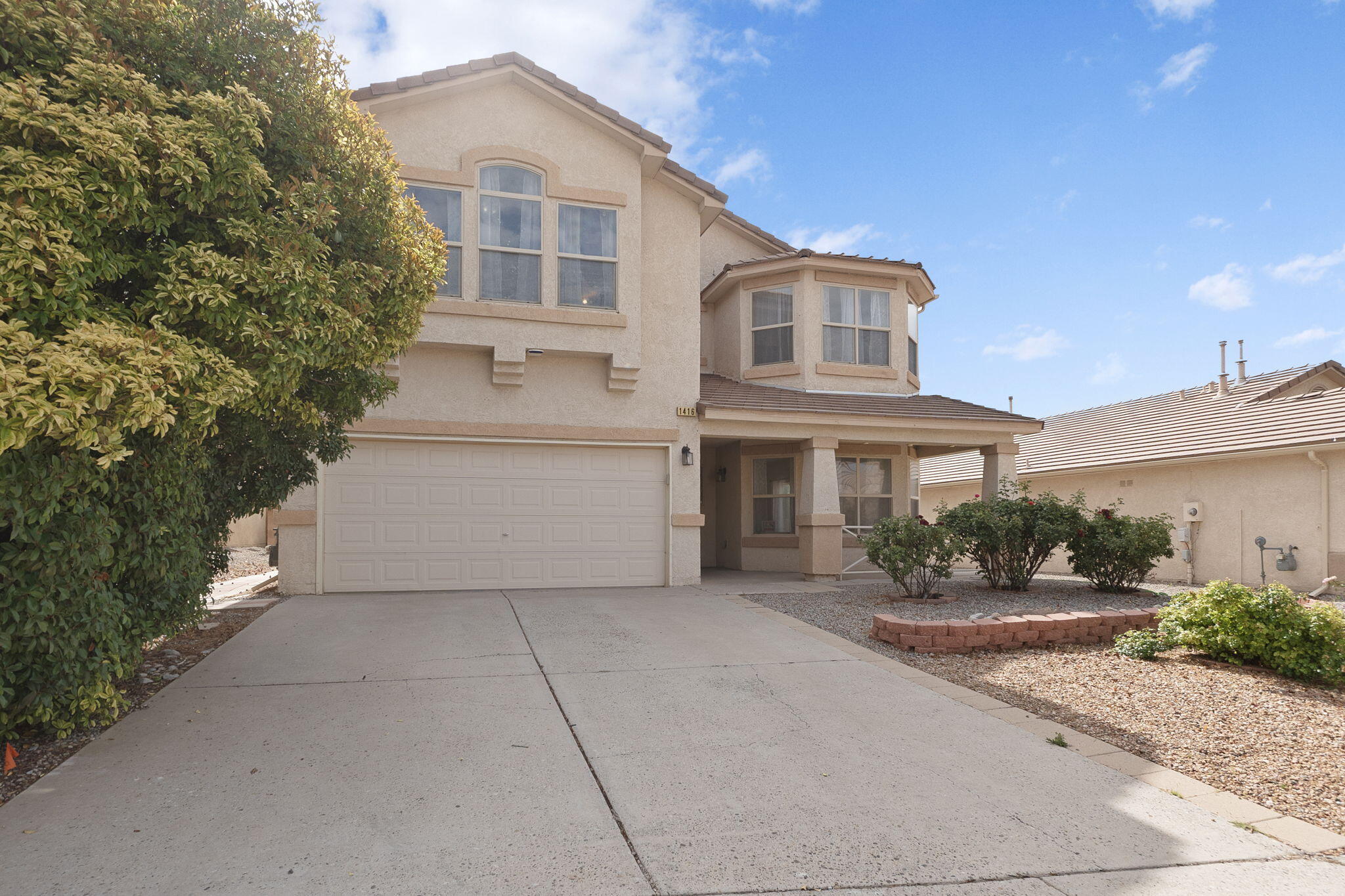 This beautifully maintained home blends charm, comfort, and functionality. Step into a bright and inviting living space featuring large windows that flood the room with natural light, tile flooring throughout the main level, and a cozy gas fireplace -- perfect for relaxing or entertaining.The exterior boasts great curb appeal with a clean, low-maintenance xeriscaped front yard and a two-car garage. Inside, the thoughtful layout includes spacious rooms and architectural touches like arched accents and bay windows.Whether you're enjoying morning coffee in the sunny living room or hosting guests in the open-concept spaces, this home is move-in ready and full of warmth.