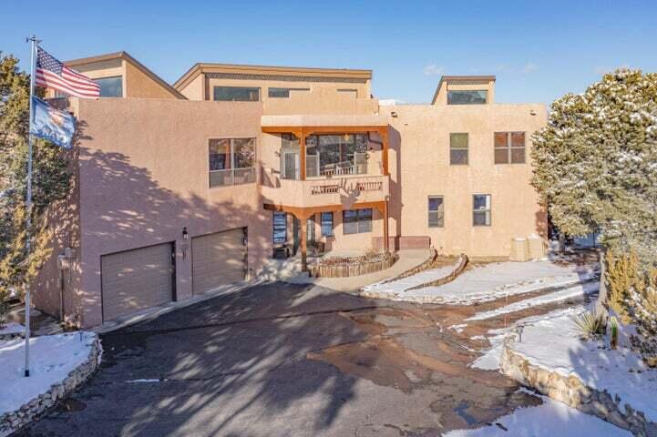 Nestled against the breathtaking backdrop of the Sandia Mountains, this unique home offers unparalleled accessibility & natural beauty. Located in a private, community, this property spans 2 acres of wheelchair-accessible trails, perfect for enjoying the outdoors. Thoughtfully designed to meet ADA standards, an open layout, & a one-of-a-kind indoor ramp that connects the main floor to the upstairs. The upstairs boasts a modern, fully equipped kitchen & a large master bedroom with an ensuite bath, all easily accessible by the interior ramps.Enjoy stunning views in every direction from the home's four balconies, offering a perfect vantage point to take in the beauty of the surrounding mountains & natural landscape. Don't miss out on this rare opportunity to own an accessible mountain home