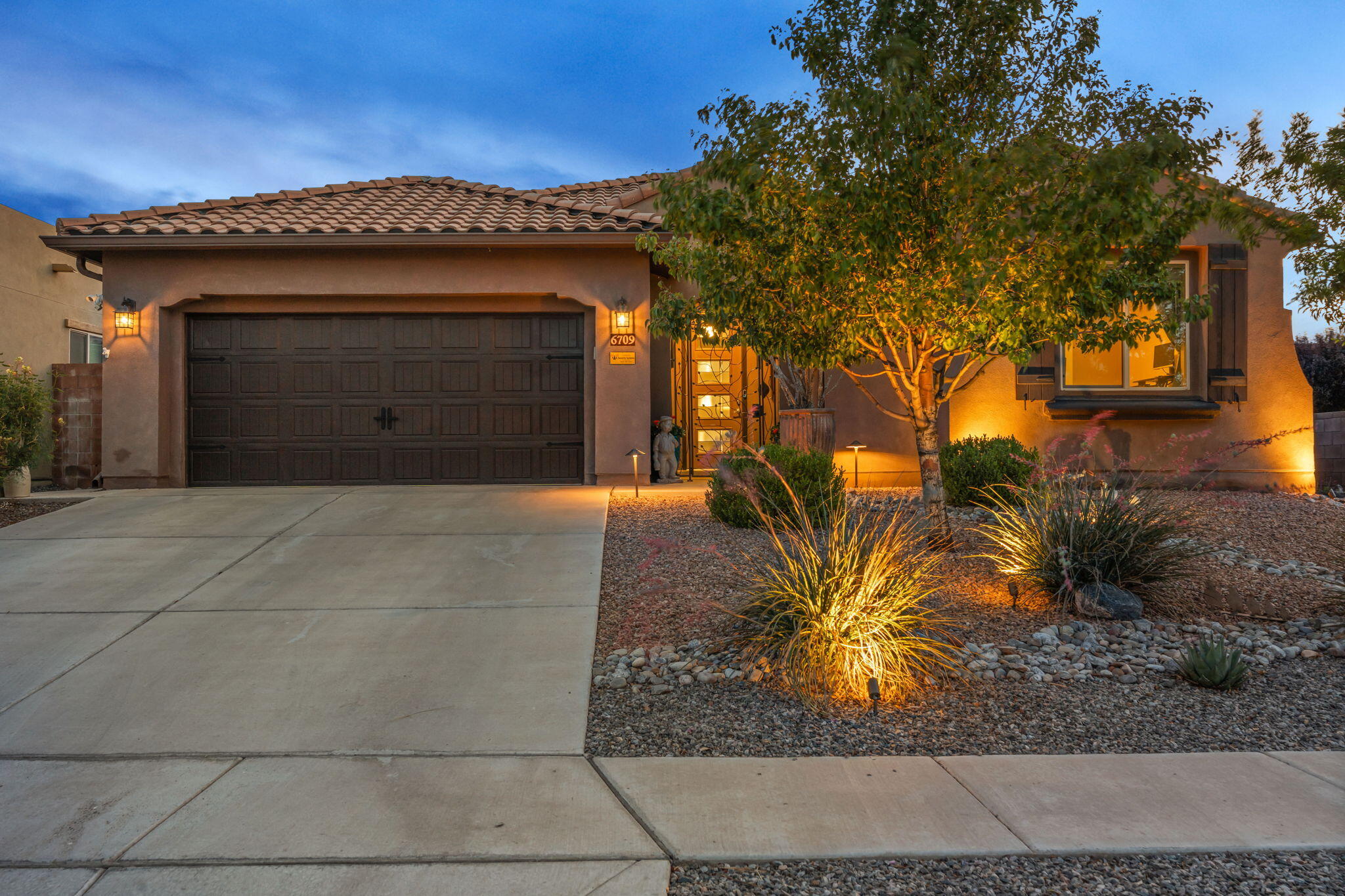 Here is a rewritten version with a warm, friendly, and luxurious tour tone within 800 characters:---Step into luxury in this beautiful Pulte home with 3 bedrooms plus an office that easily becomes a 4th bedroom. You'll love the open floor plan featuring a great room with an electric fireplace and large sliding doors that flow to your stunning outdoor living area, complete with a fireplace under the covered patio and elegant lighting. The kitchen shines with a spacious island and stainless appliances. Enjoy newer carpet, custom blinds, a custom-designed primary closet, and a stylish newer front door. The finished garage offers epoxy floors, custom shelves, and extra storage for all your needs.
