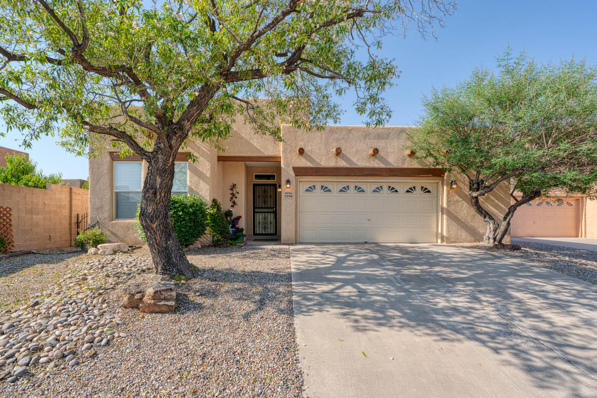FABULOUS single story 3 BR 2 bath, and 2 1/2  car garage in a well established NW neighborhood.  Beautiful and private PARK LIKE BACKYARD with huge covered patio and mature trees to beat the summer heat - a true oasis! Fully landscaped with low maintenance xeriscape, sprinklers anddrip irrigation. Home features: fresh paint, refrigerated AC, custom tile workaccents throughout. REMODELED GOURMET KITCHEN withstainless double ovens, dishwasher and sink as well as inductioncooktop, and granite countertops withbreakfast bar for 8, XL walk-in pantry and lots of cabinets.ALL OCCASION ROOM canbe used as formal dining/office/bonus room. LARGE GREAT ROOM has12ft tall ceilings and stunning KIVA FIREPLACE with custom tilework and gas logs, and huge windows looking out over