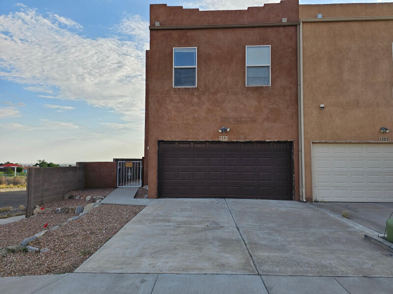 Charming Fixer-Upper with Great Potential! This two-story townhome features 3 bedrooms - all bedrooms and 2 bathrooms located upstairs along with a convenient hallway laundry closet. The main level offers a bright living room with access to the private patio and low-maintenance backyard, a functional kitchen with a breakfast bar, and a guest half bath. A spacious two-car garage provides excellent storage and parking. Additional highlights include a side yard, no HOA, and a desirable location just minutes from the Foothills, I-40, shopping, dining, and a brand-new movie theater. Don't miss this opportunity--schedule your showing today!