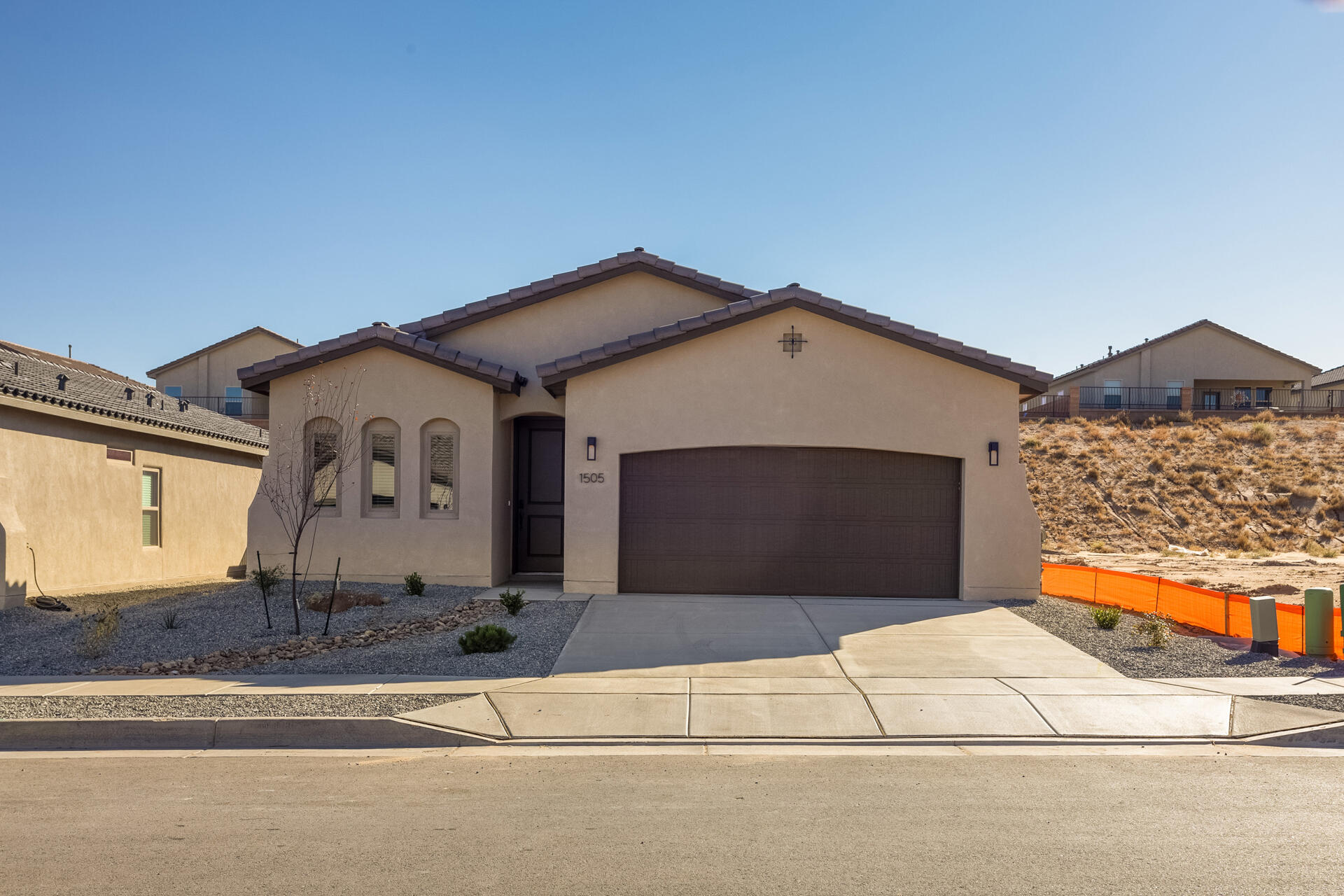 This beautiful Maya floor plan, located in the vibrant Mil Colores neighborhood within the Fiesta Master Planned community in Los Lunas, features a stylish design with upgraded amenities. This ranch-style home offers sleek, modern lighting, upgraded appliances, and refined interior finishes, including upgraded tile flooring, beautiful white and gray quartz countertops, and warm brown shaker cabinets. It includes 3 bedrooms, 2 bathrooms, and a generously sized backyard with endless possibilities for creating your own oasis.