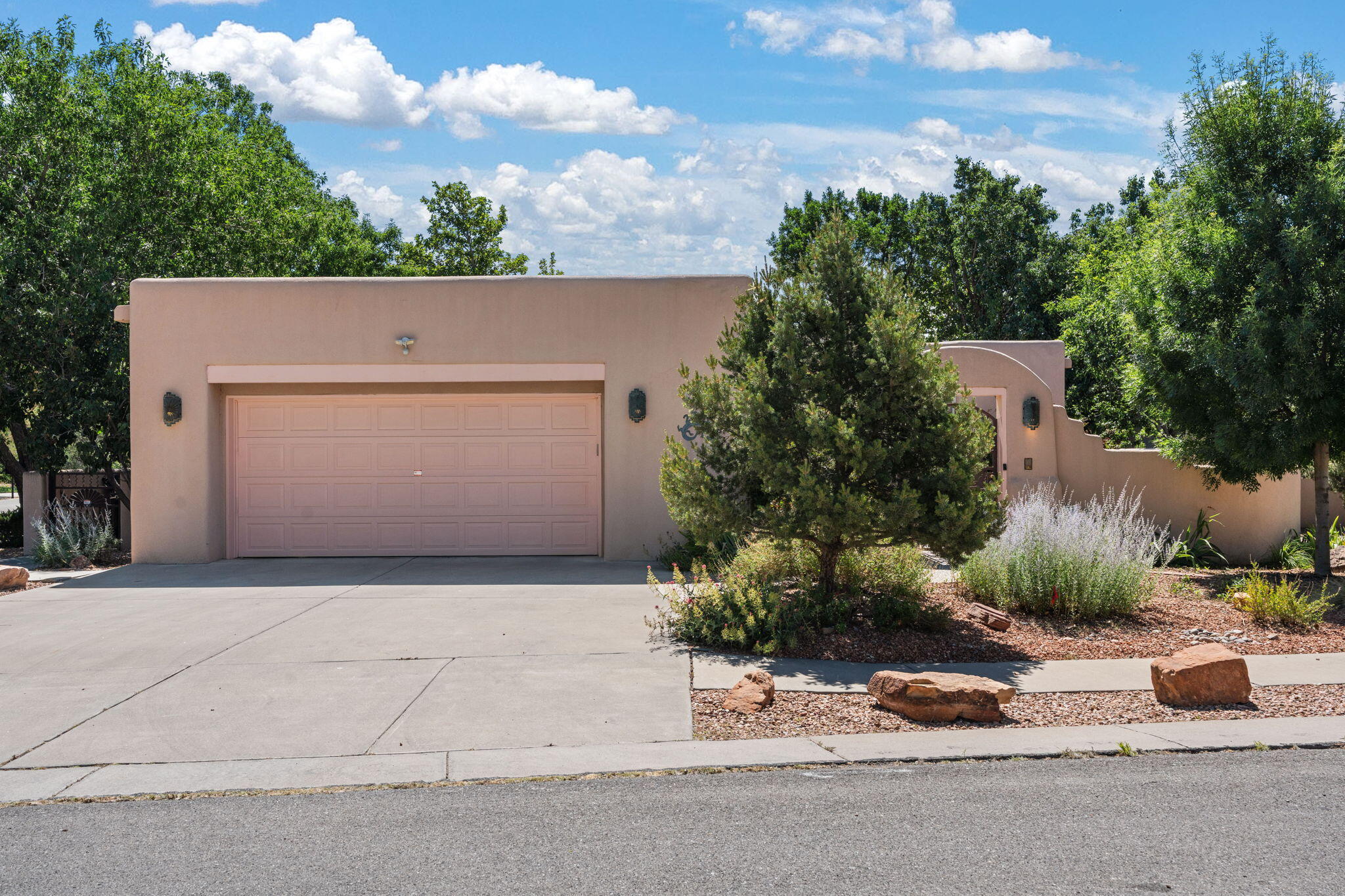 Welcome to 2308 Via Madrid Drive NW, a thoughtfully crafted single-story home nestled in a quiet, walkable neighborhood built by the respected Homes by Marie. With 2,028 square feet of well-designed living space, this 3-bedroom, 2-bathroom home invites you to settle into a lifestyle of ease and beauty--surrounded by mature landscaping, winding walking trails, and a nearby community park.Step through the gated front courtyard and into a space that feels both warm and refined. The eat-in kitchen, complete with a gas cooktop and warming drawer, offers peaceful views of the shaded backyard--perfect for slow mornings and lively dinner prep alike. Ceramic tile floors carry you through the high-traffic areas with style and ease, while soft carpet in the bedrooms adds a layer of comfort where