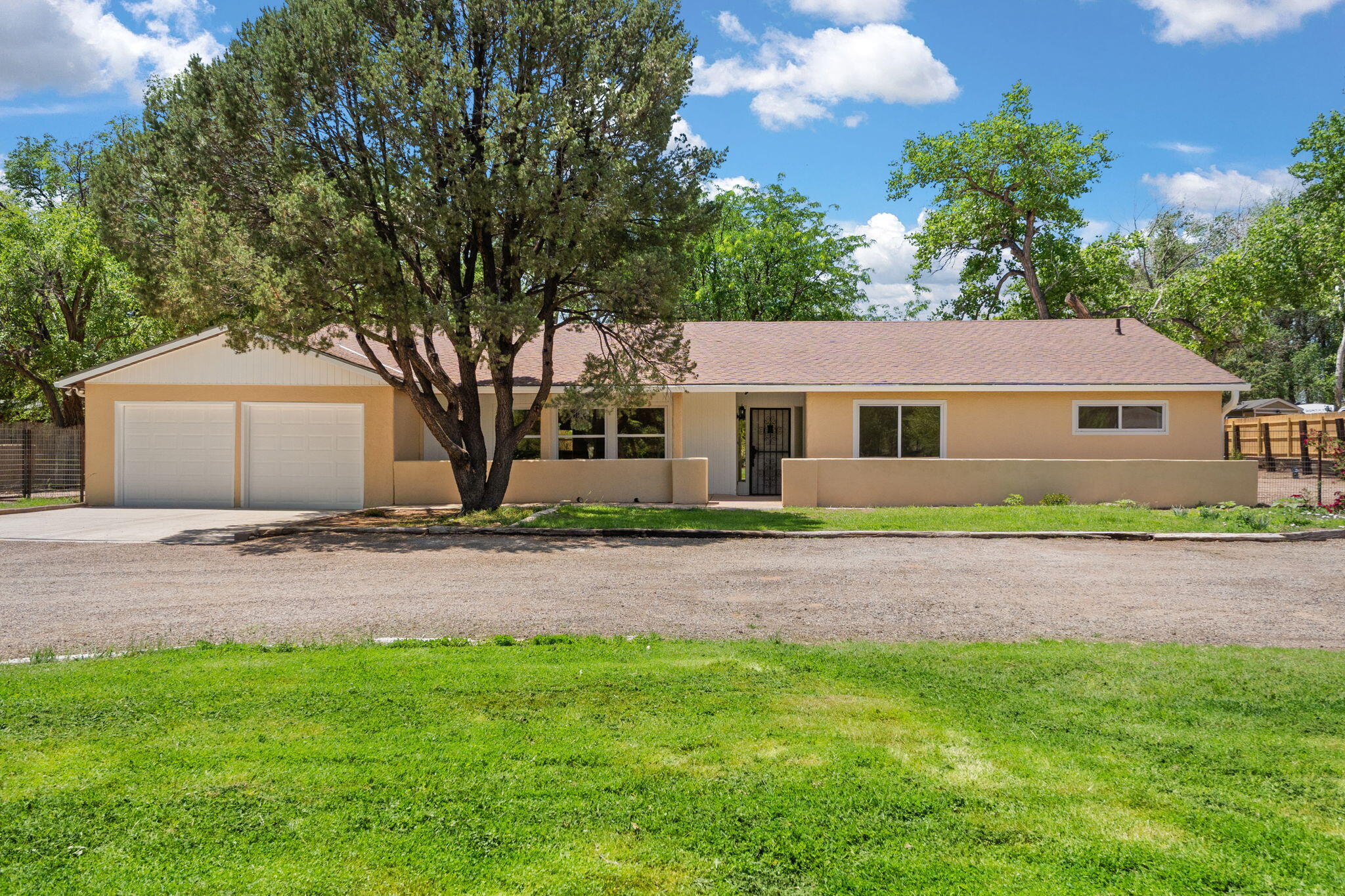 Welcome to your serene escape in the heart of Corrales. This spacious 2,926 sq ft single-family home sits on a lush 0.9-acre lot, offering the perfect blend of rural tranquility and modern updates. Thoughtfully renovated, this 3-bedroom, 2.5-bath home boasts freshly painted stucco, new flooring throughout, updated interior paint, a brand-new chimney, plush new carpet in the bedrooms, and updated kitchen countertops -- creating a bright and inviting living space ready for its next chapter. The expansive layout includes multiple living areas ideal for entertaining, relaxing, or working from home. Generous windows and skylights bring in abundant natural light, while the property's size and layout offer space for gardening, outdoor living, or just a relaxing environment.