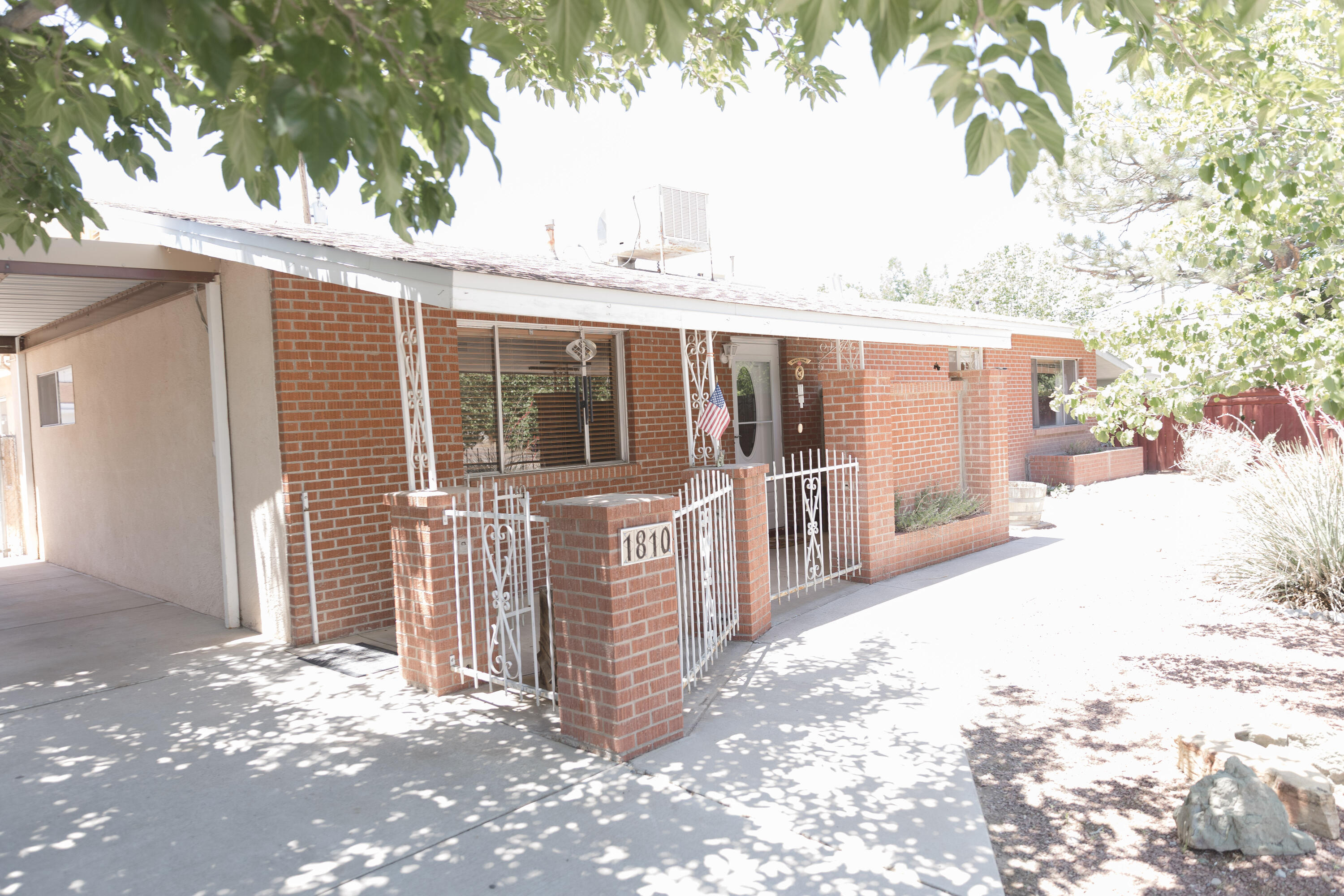 Charming North Valley Gem with Detached Studio Space! Welcome to 1810 Miller Circle NW, Albuquerque, NM 87107 -- a beautifully maintained 3-bedroom, 2-bathroom home offering 2,129 sq ft of spacious living on a generous 0.25-acre lot, nestled in the heart of the desirable North Valley. This unique property features: A detached ~480 sq. ft workshop or ideal mother-in-law quarters / casita. Perfect for guests, a home office, or creative space. Two-car carport for easy covered parking. Large, private lot with mature trees and space to garden or entertain. Quiet, established neighborhood.  Inside, you'll find warm, welcoming living spaces filled with natural light, and a flexible floor plan.(the ~480 sq. ft workshop is NOT included in the overall square footage of 2129)