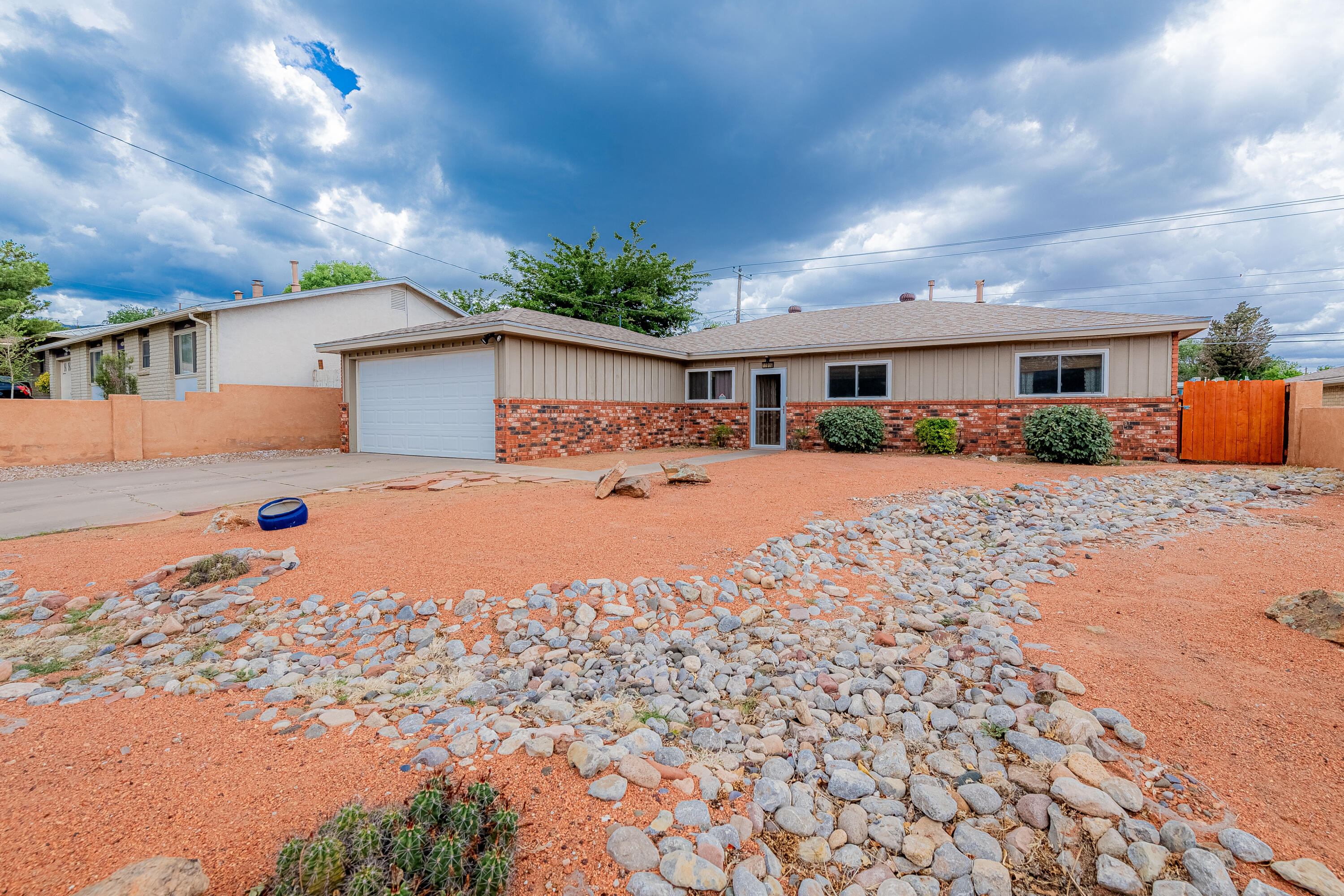 Charming single-story home with stunning Sandia views! Featuring 3 beds plus office or possible 4th bedroom, 2 baths, and 2 living areas, this well-maintained home offers an updated kitchen with butcher block countertops, stainless steel appliances, and ample cabinet space. Both bathrooms are beautifully remodeled with tile surrounds and updated vanities. Enjoy low-maintenance landscaping front and back, a large covered patio, and a private backyard with block walls, perfect for relaxing or entertaining. Includes a storage shed and a two-car garage.